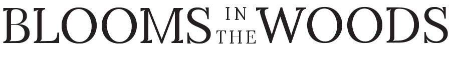 Rustic logo design with text reading 'BLOOMS IN THE WOODS' in classic typography.