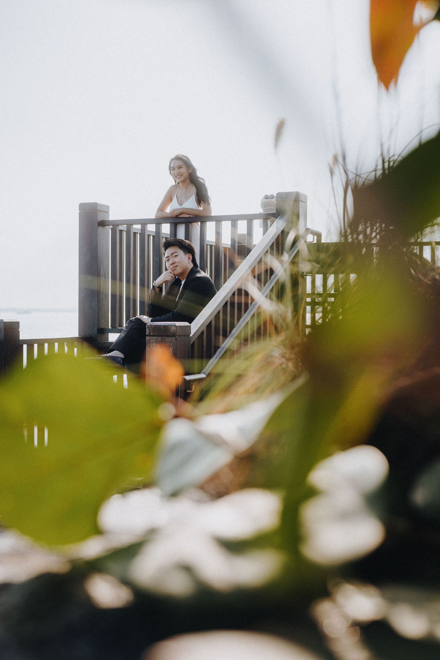 Two figures enjoying a peaceful moment on an outdoor observation deck.