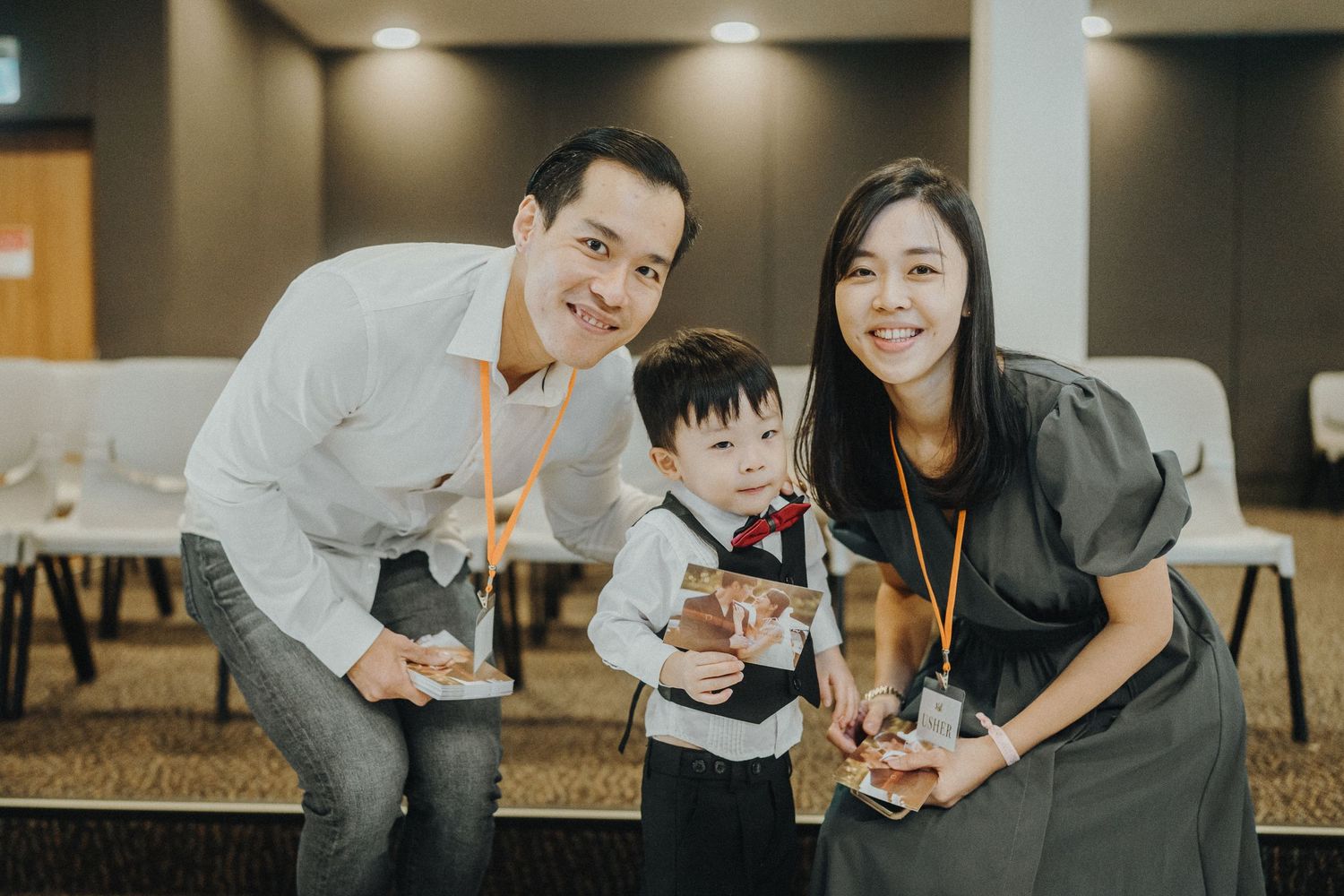 A family poses together holding bubble tea drinks in a casual indoor setting.