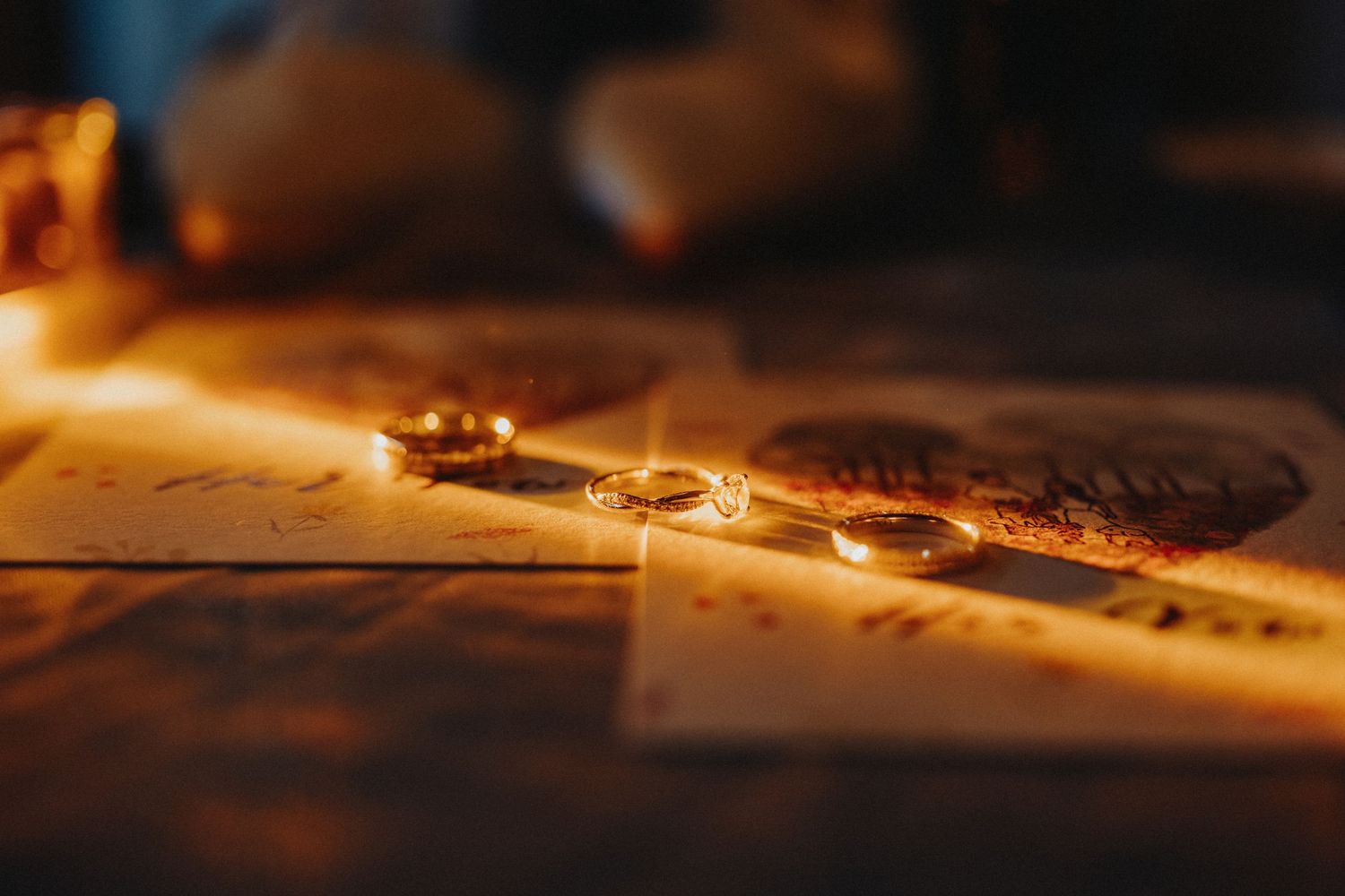 Glowing coffee beans scattered on a wooden surface illuminated by warm golden light in macro photography.