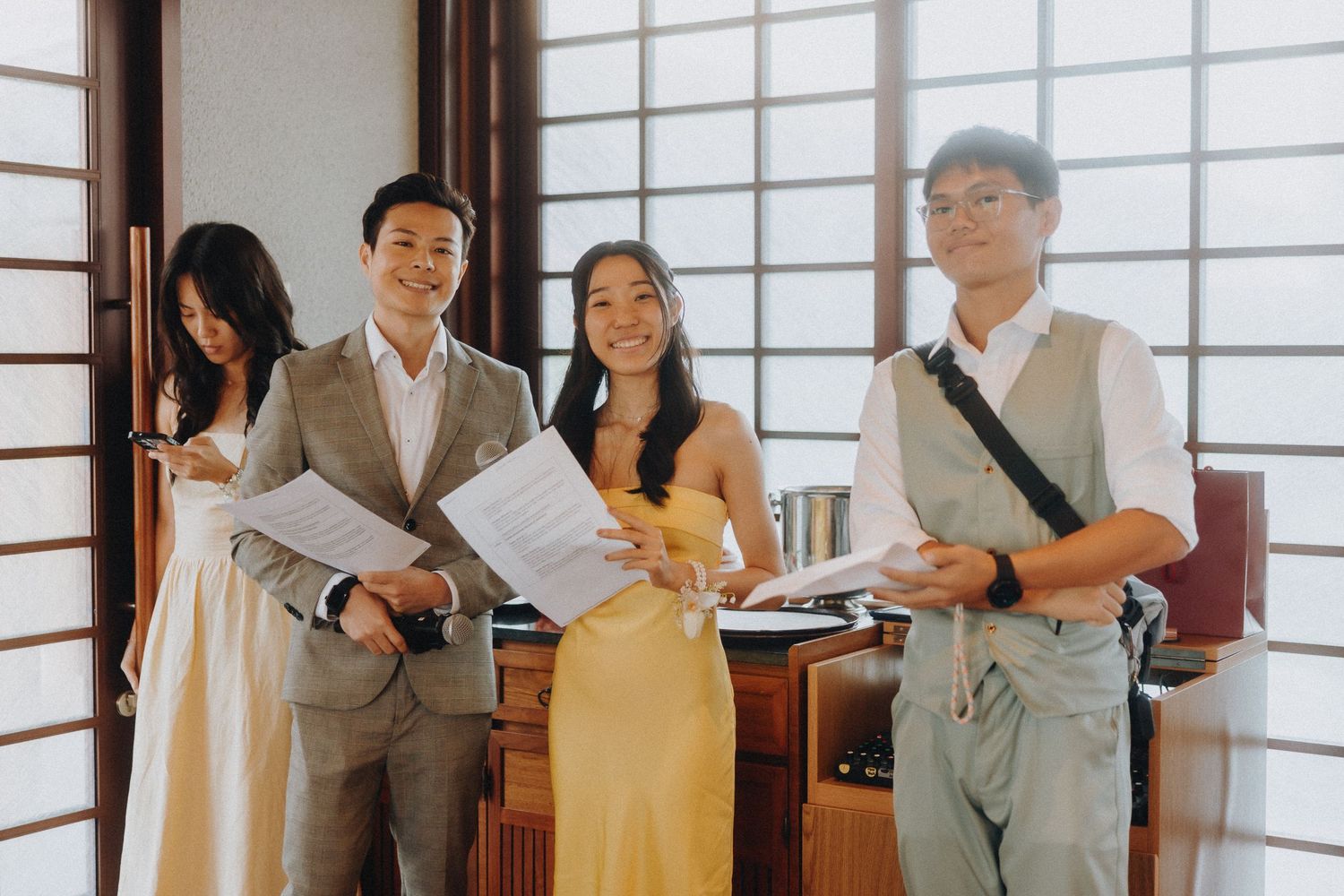 Group reviewing documents together in traditional Japanese room with sliding doors.