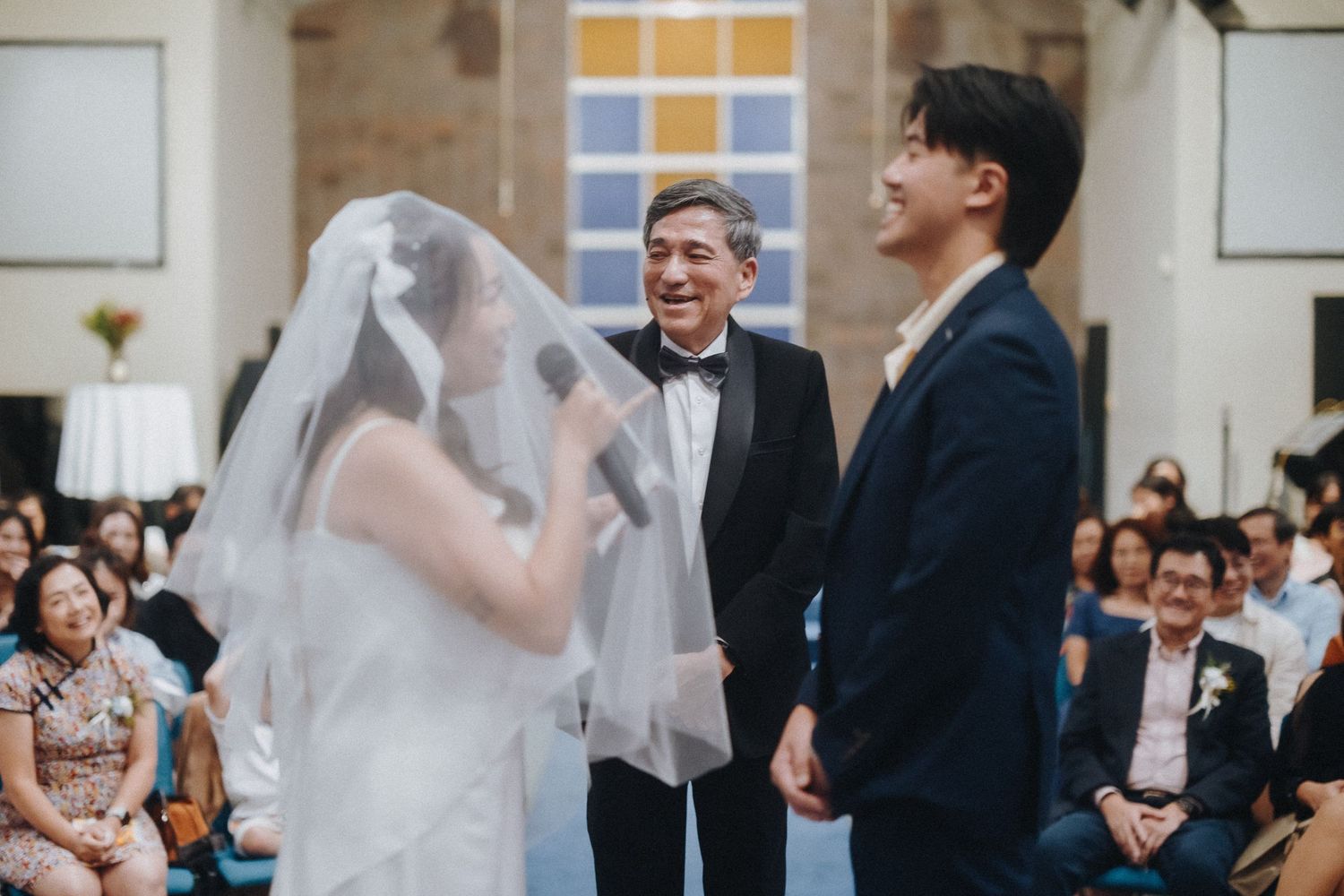 Joyful wedding celebration moment with attendees in formal attire.