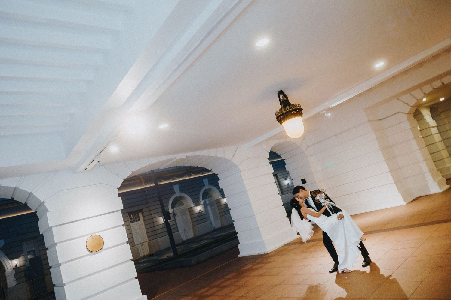 A sequence of dance moves captured in an indoor venue with white ceiling and wooden floors.