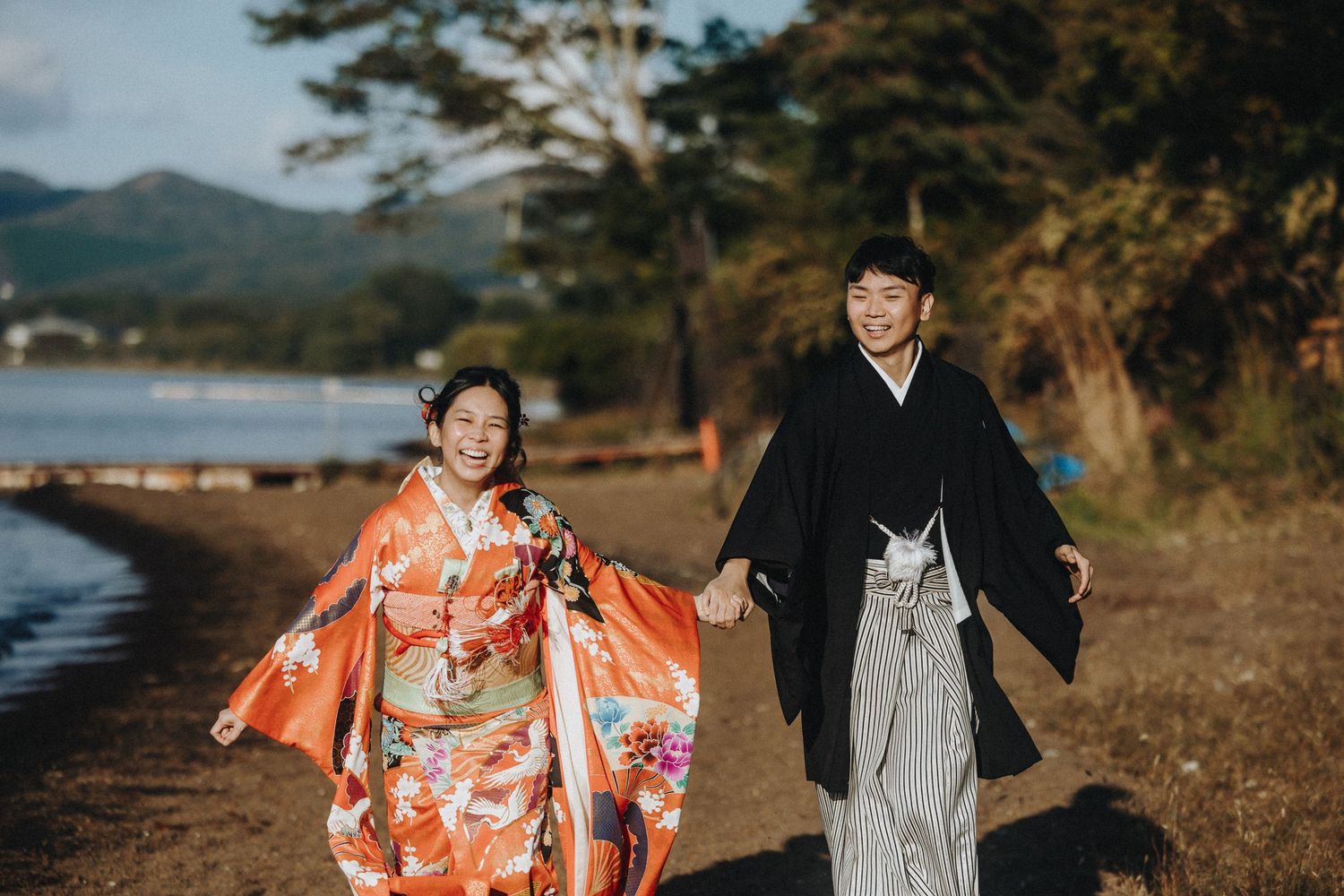 Traditional Japanese wedding photoshoot against stunning mountain and lake backdrop.