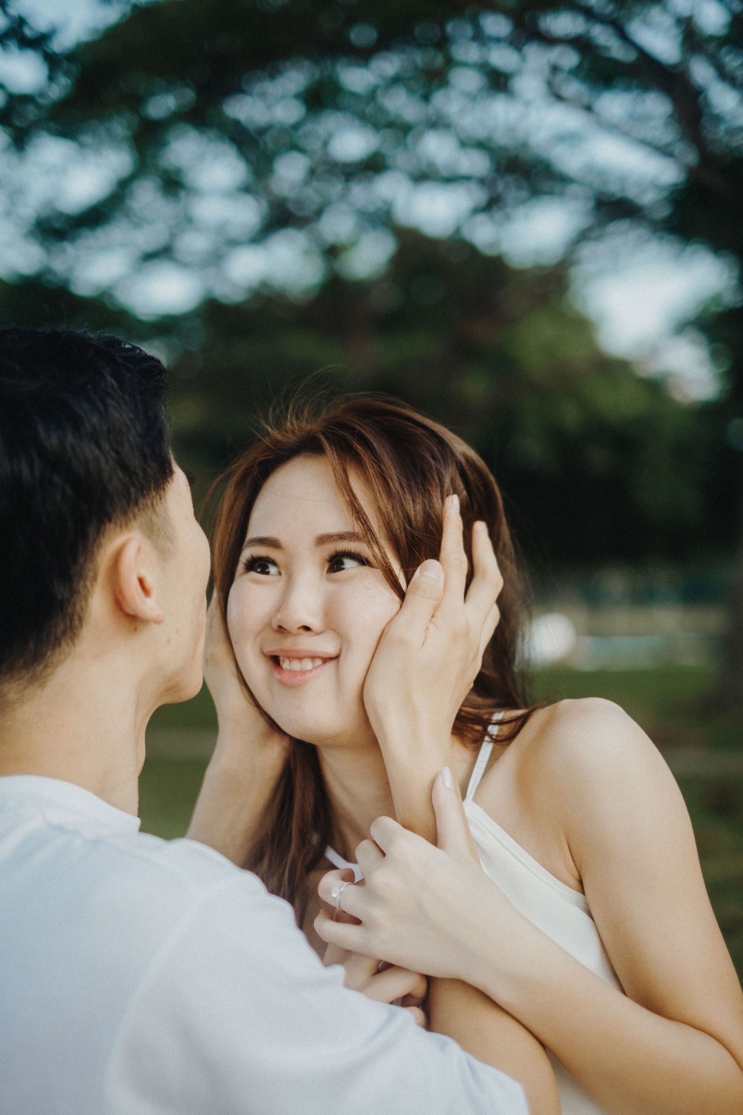 Intimate moment between couple in garden setting.