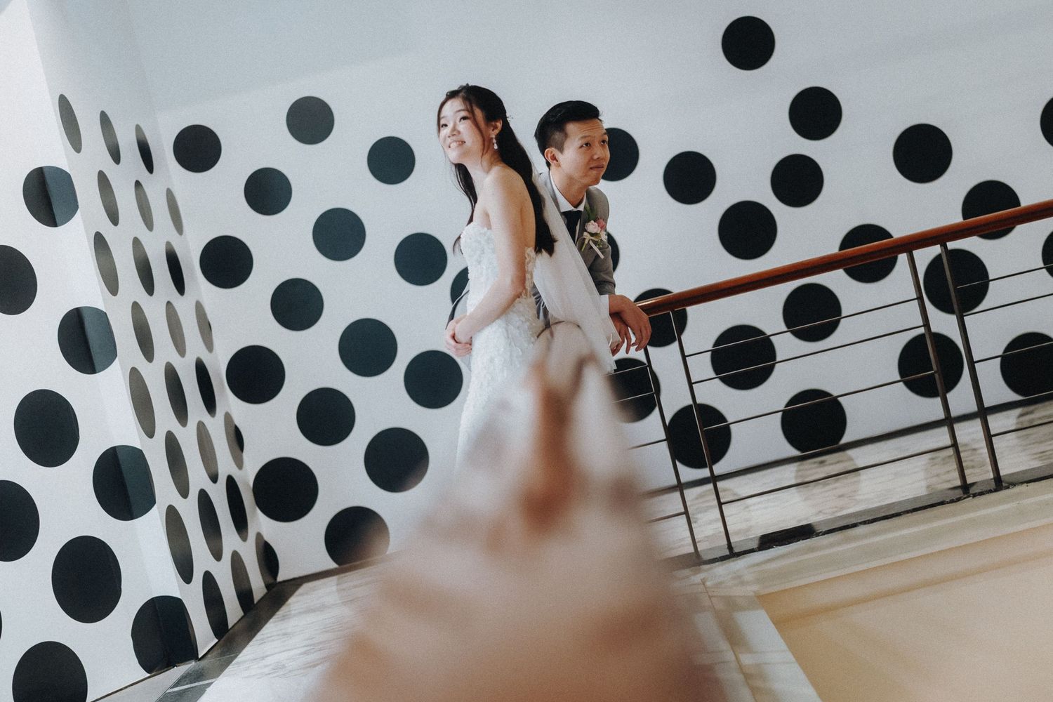 Modern wedding venue with polka dot wall design and reflective surfaces.