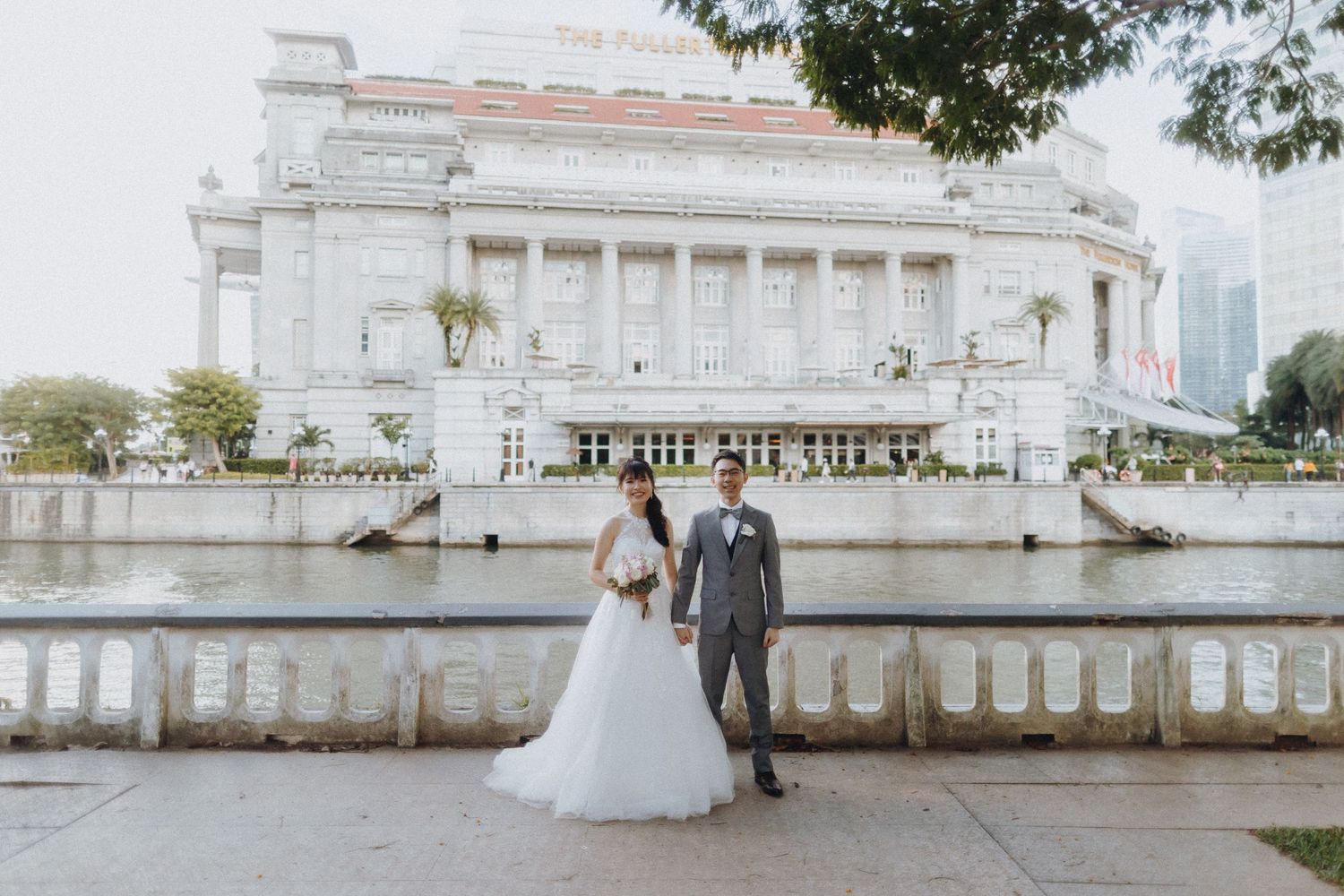 Elegant wedding photoshoot at a white neoclassical building with grand columns and architecture.