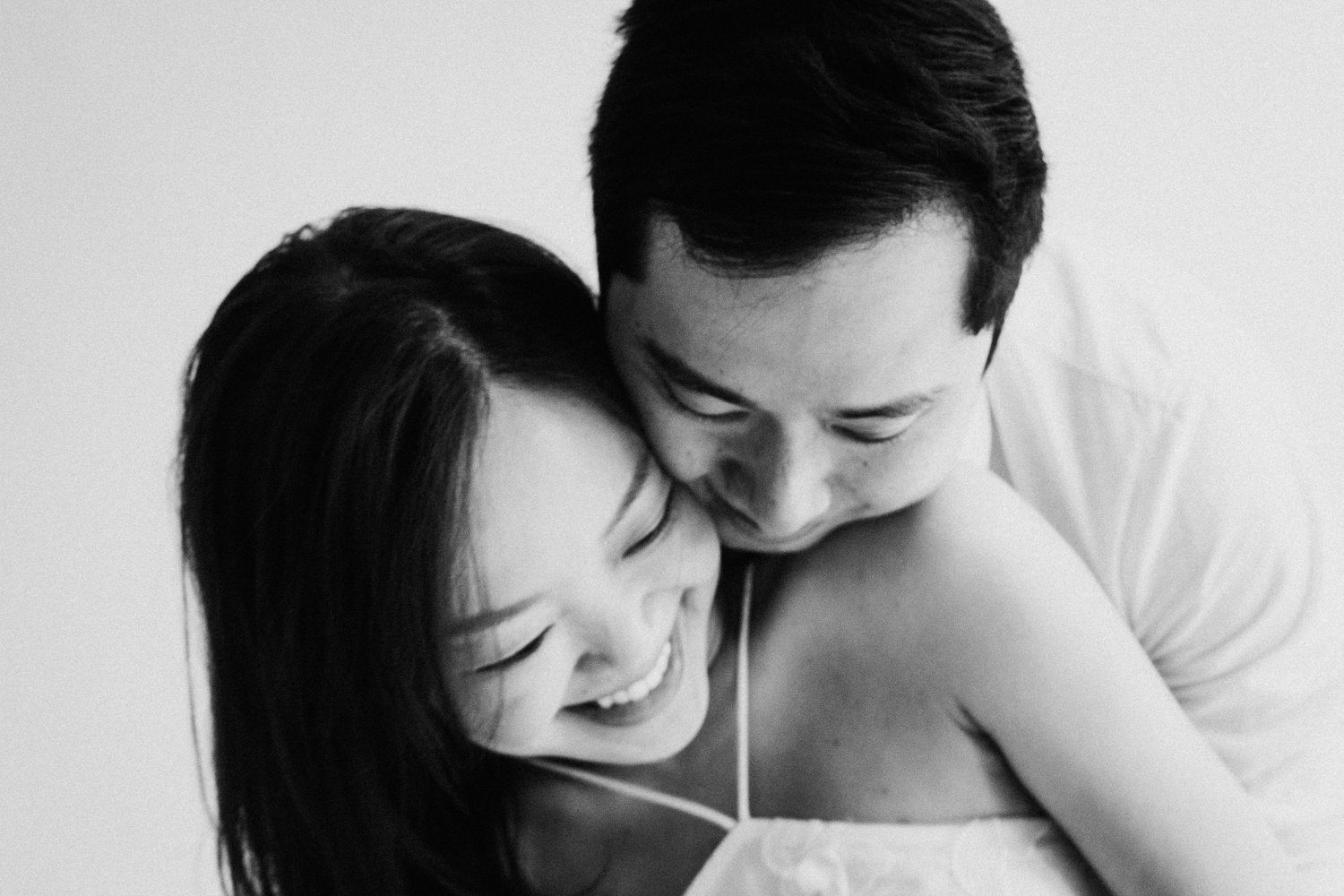 A series of tender black and white photos showing couples sharing intimate embraces and moments together.