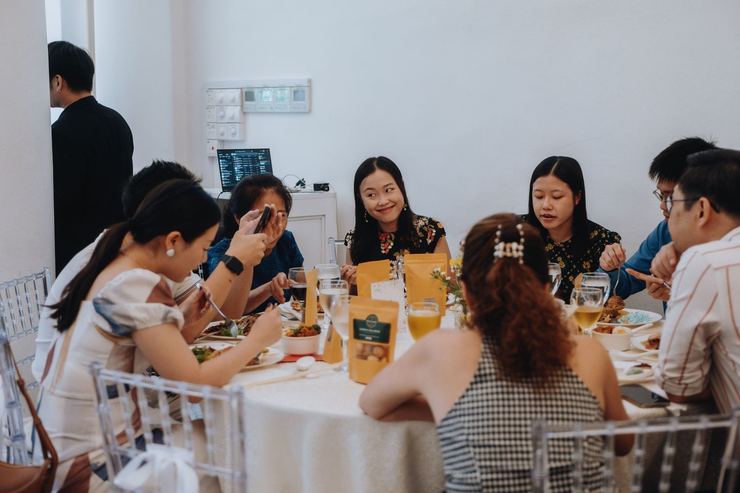 Group of Asian women dining together at a round table during a social gathering or corporate event.