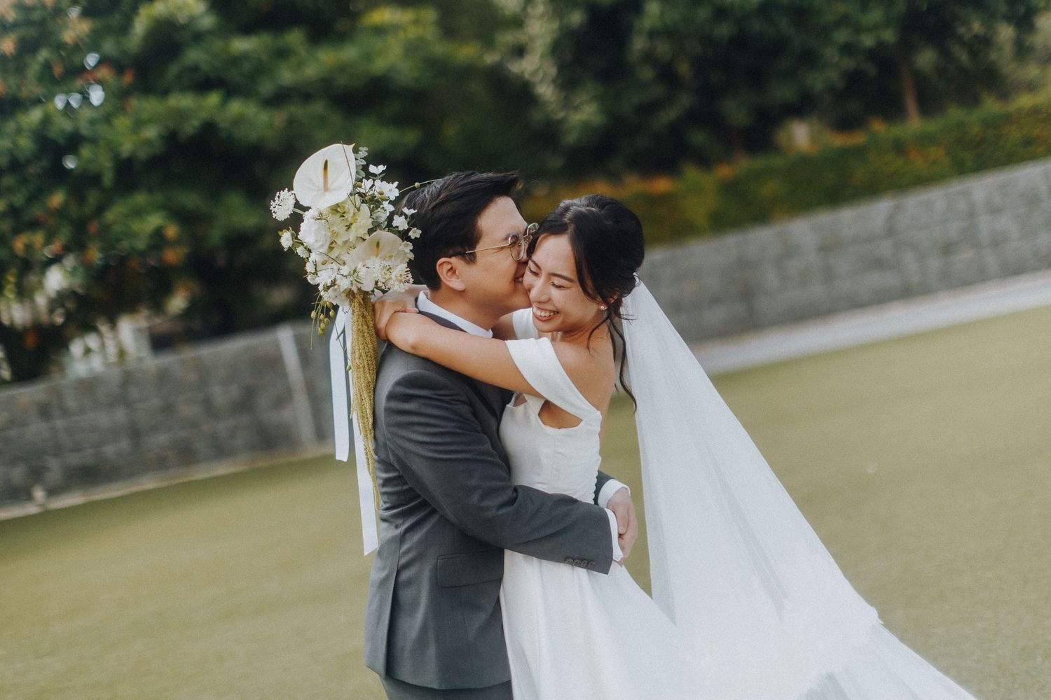 Romantic wedding photoshoot moment captured in a beautiful outdoor garden setting.