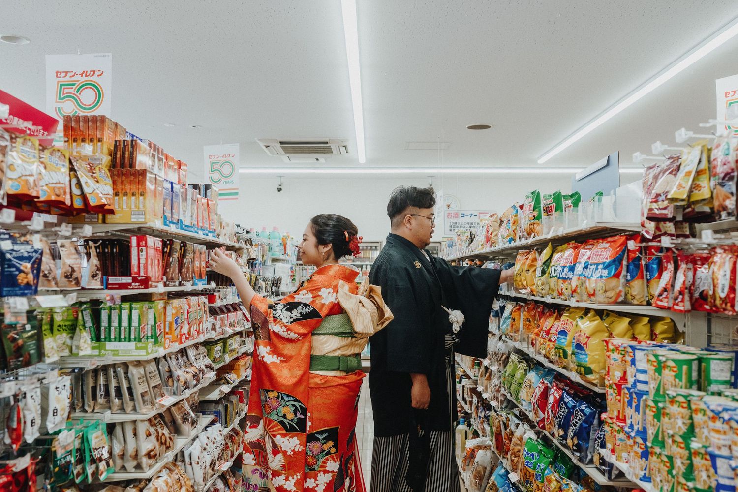 Interior view of a Japanese convenience store with colorful product aisles.