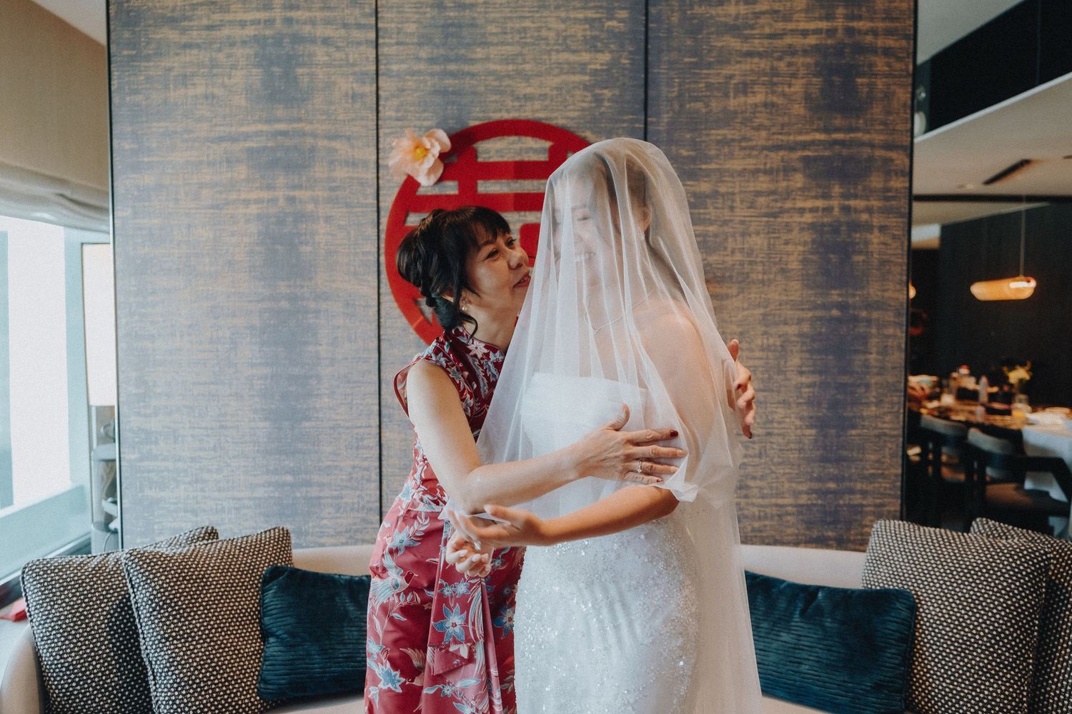 A group mingles and socializes at an intimate gathering in a rustic brick-walled venue.