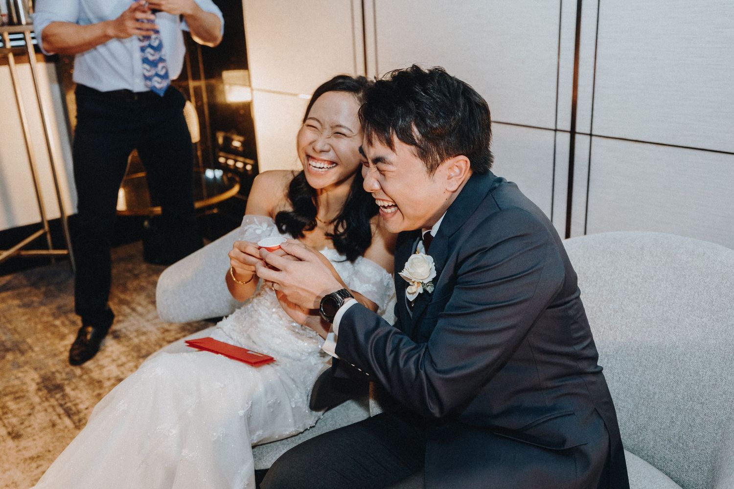 A candid moment of laughter shared during a wedding reception.