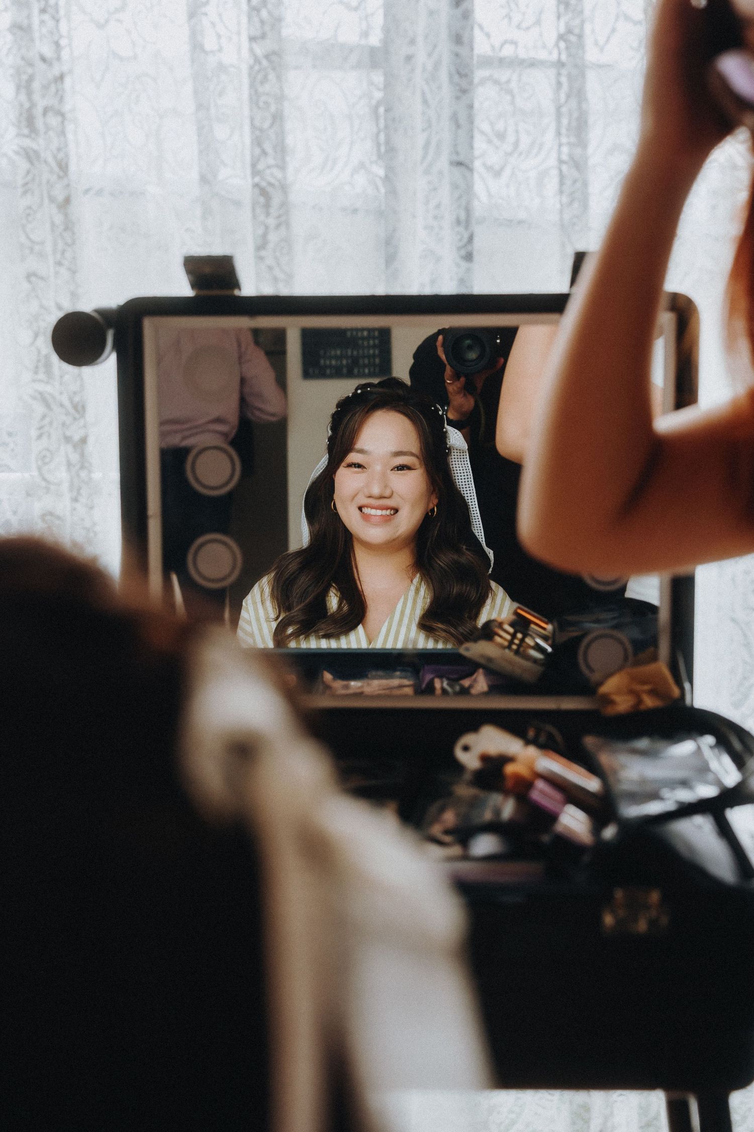 Behind-the-scenes beauty shot showing a makeup session being filmed on camera.