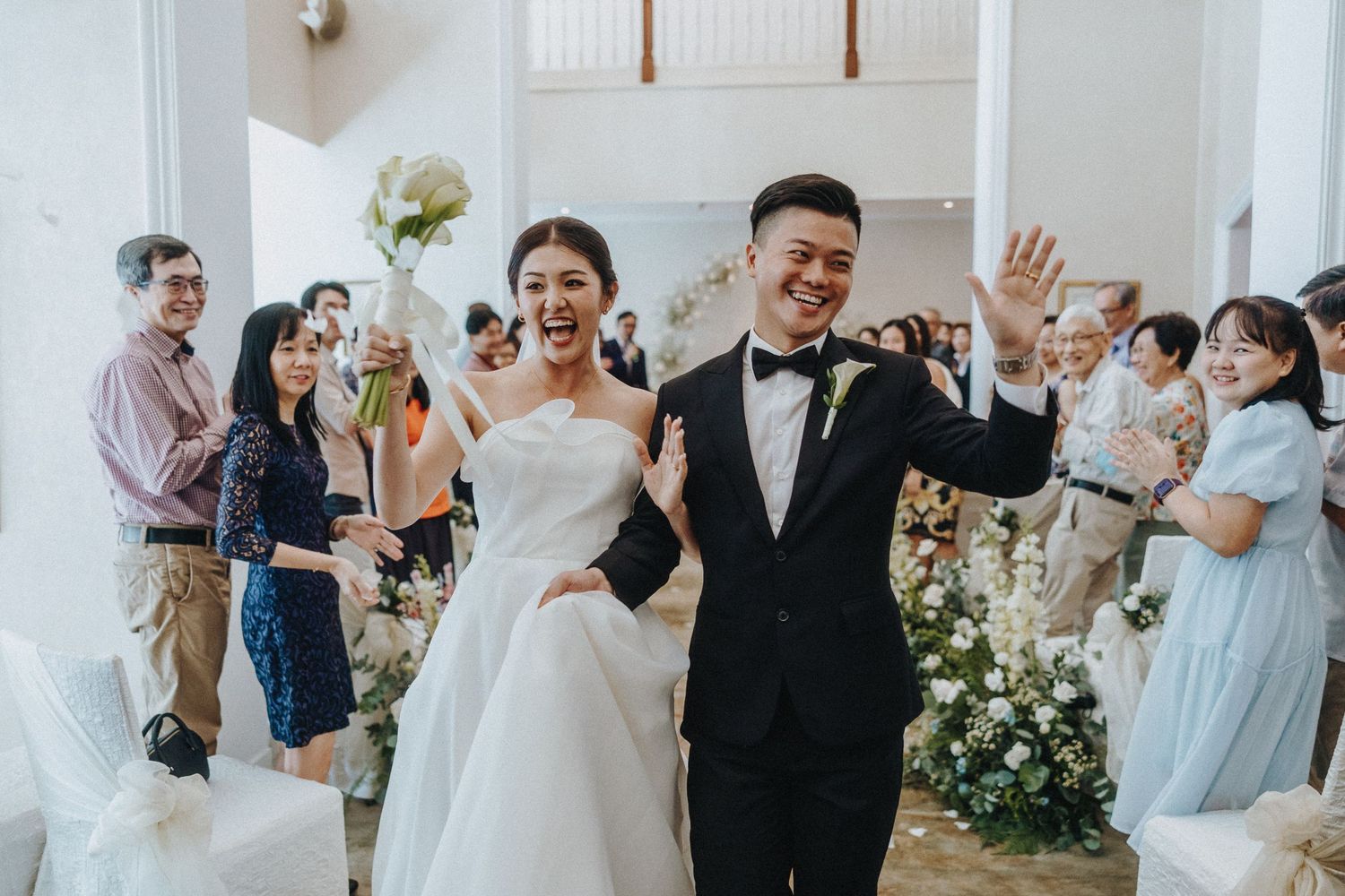 A celebration at a wedding venue with floral decorations and festive atmosphere.