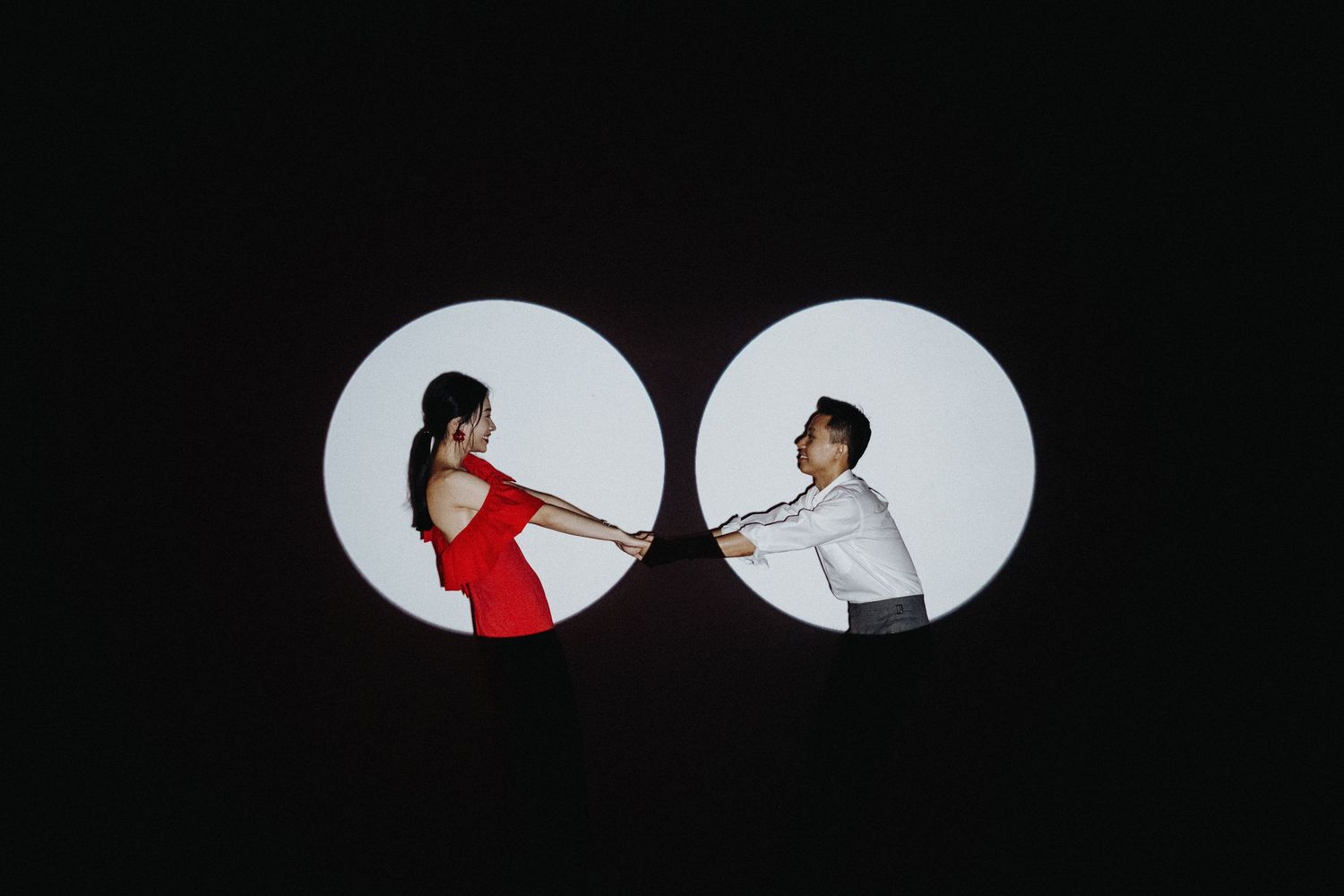 A split circle shape shows a dramatic silhouette scene of two people in a dynamic martial arts combat pose.