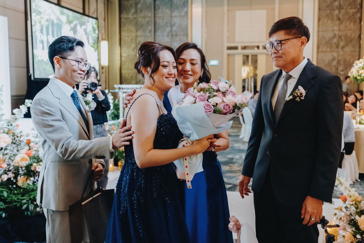 A joyful celebration moment at an elegant wedding reception with formal attire.