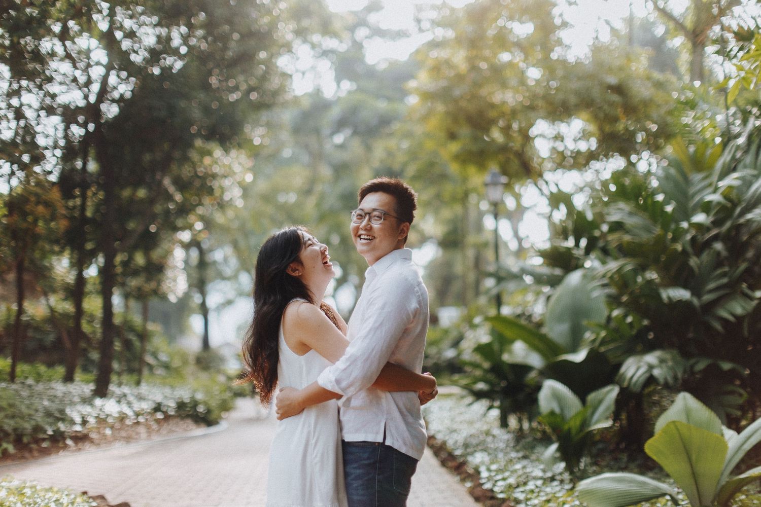 A romantic outdoor photoshoot in a lush tropical garden setting.