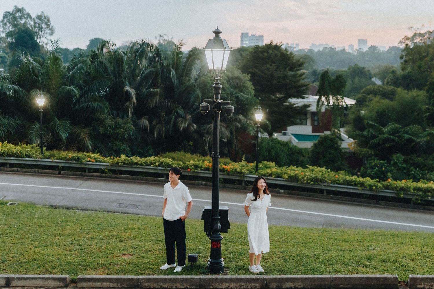 A series of romantic outdoor wedding photos at sunset with couples posing against scenic park backdrops and lamplight.