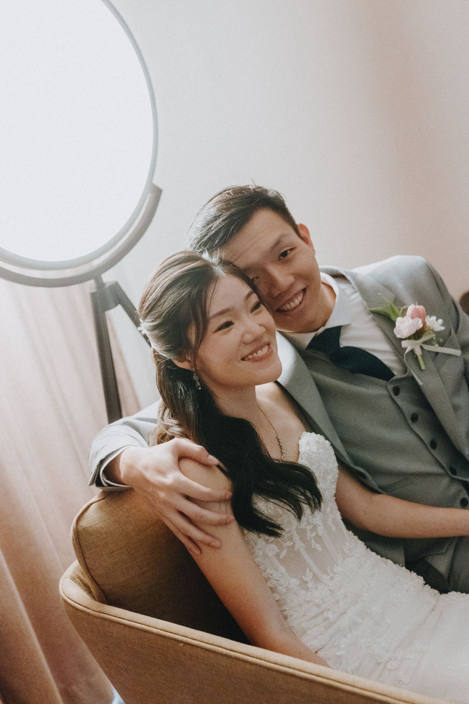 Romantic wedding couple sharing an intimate moment while sitting together in front of a mirror.