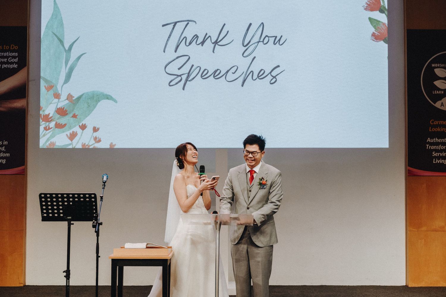 A joyful slow dance moment between a couple during their wedding reception, surrounded by decorative lighting.