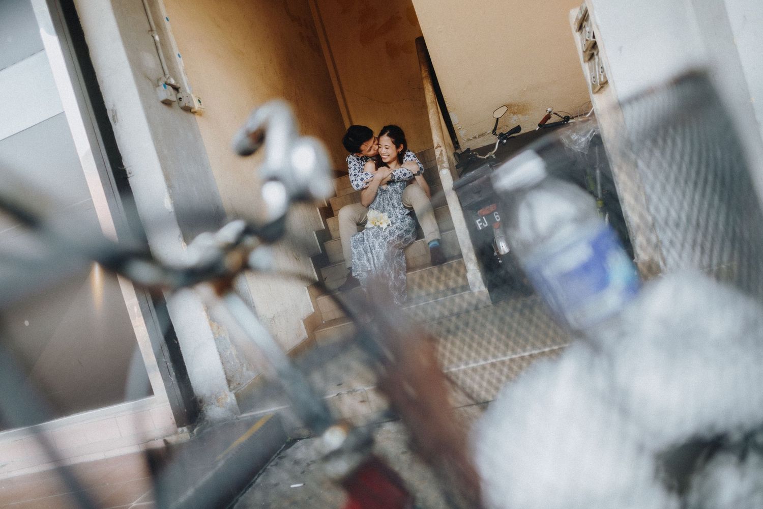 A romantic moment captured through glass with artistic blur and reflections.