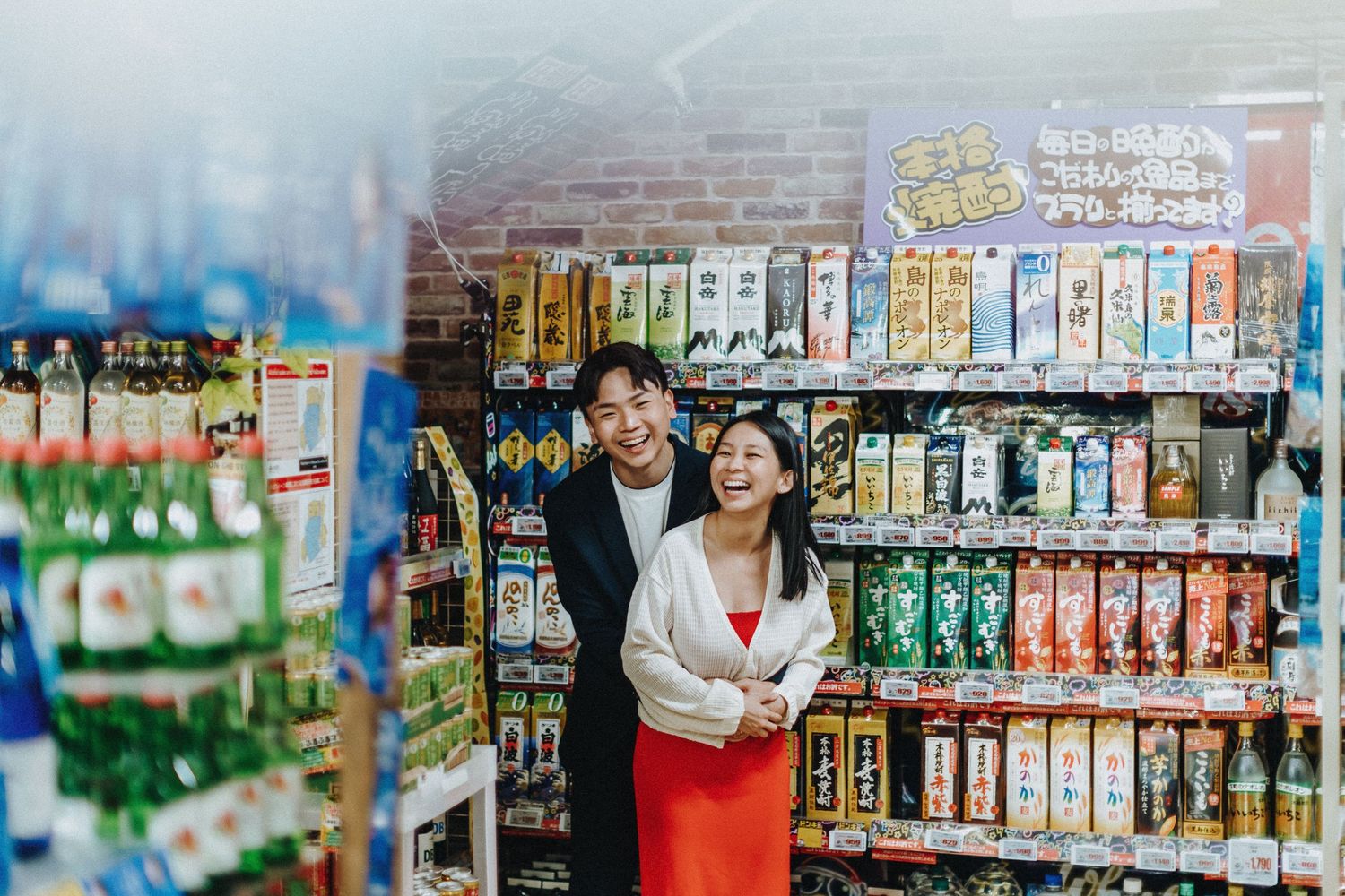 Couple browsing together in a colorful convenience store aisle.