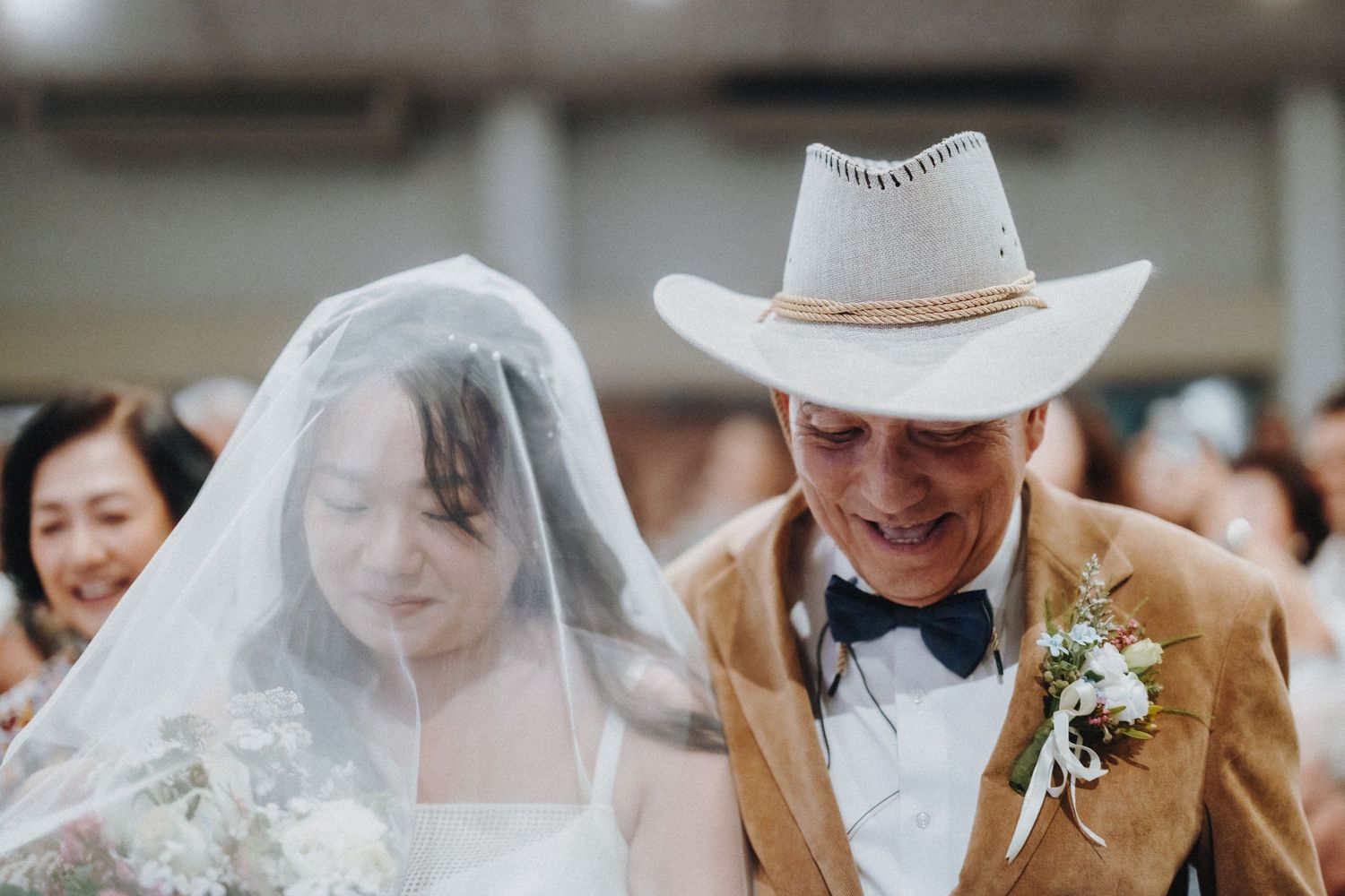 Close up of bride and groom sharing a joyful moment during their wedding ceremony.