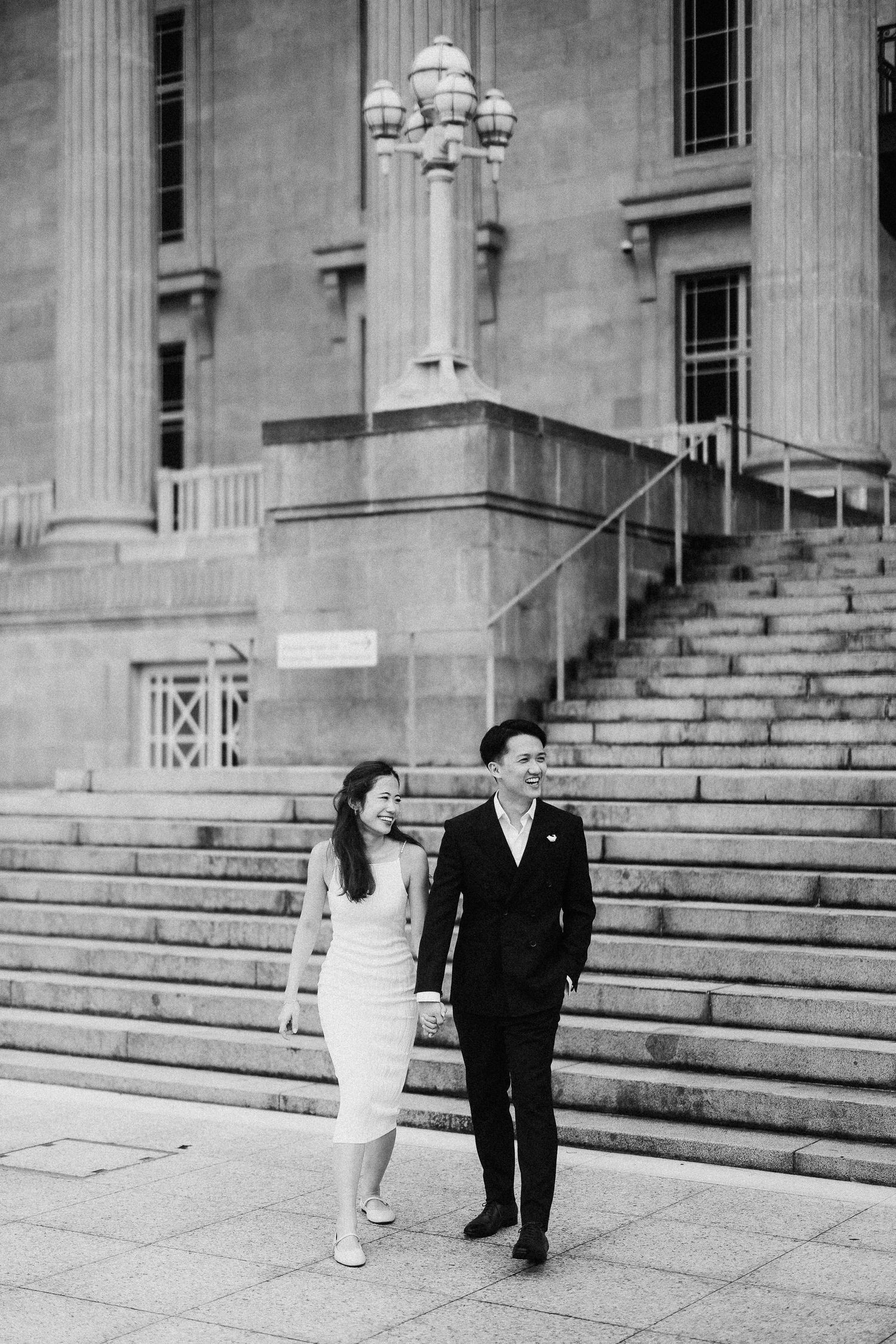 A black and white photo sequence shows a couple walking down stone steps in front of a neoclassical building.