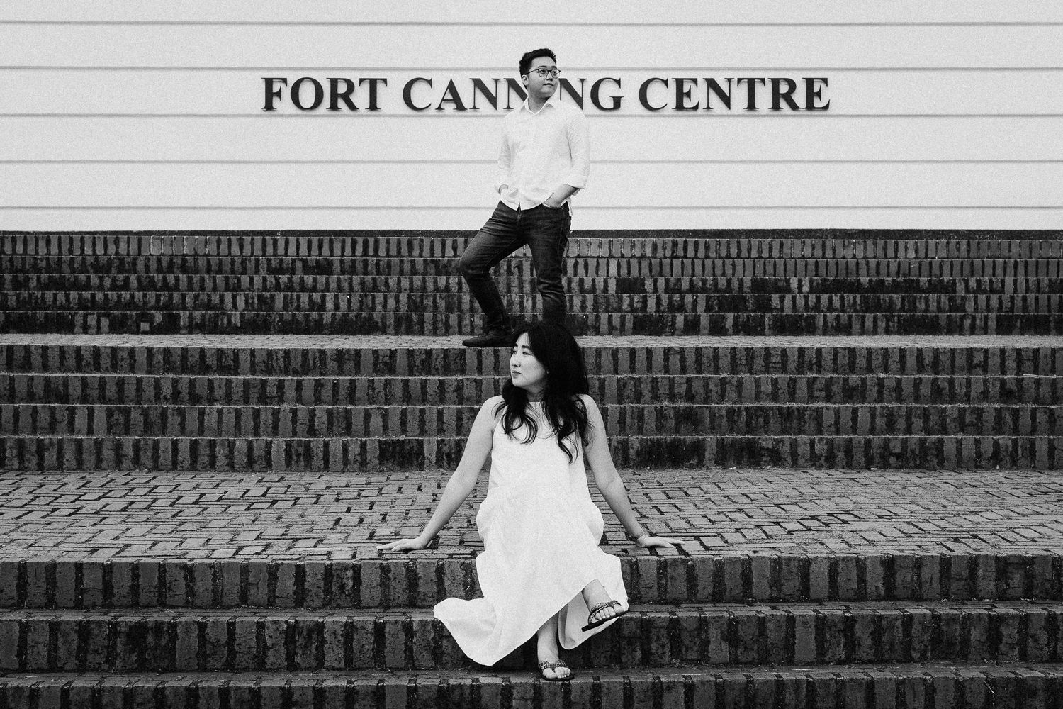 White dress set against architectural steps at Fort Canning Centre creates a dramatic contrast in black and white.