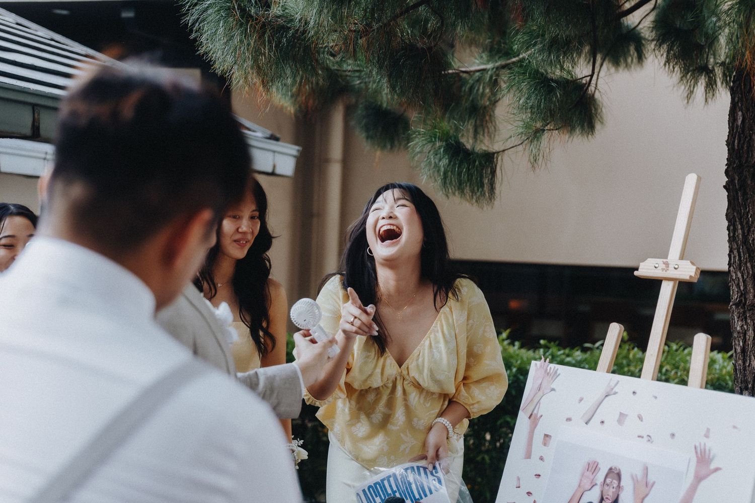 A wedding celebration scene with guests in festive attire enjoying a joyous moment.