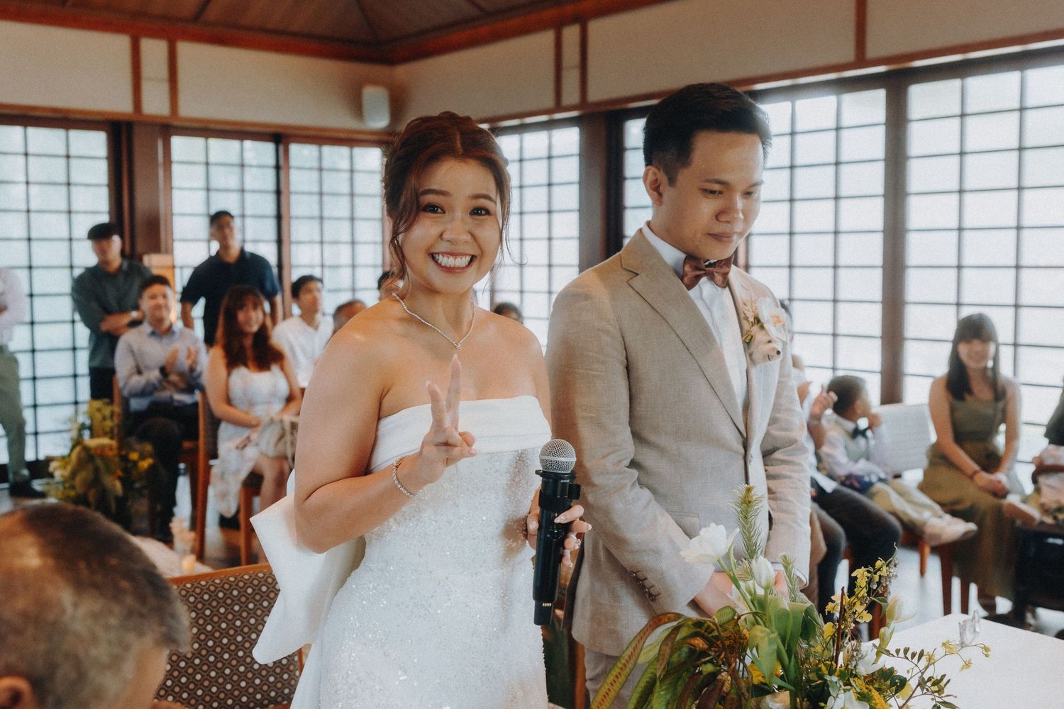 A wedding ceremony in a Japanese-style room with paper screens and wooden details.