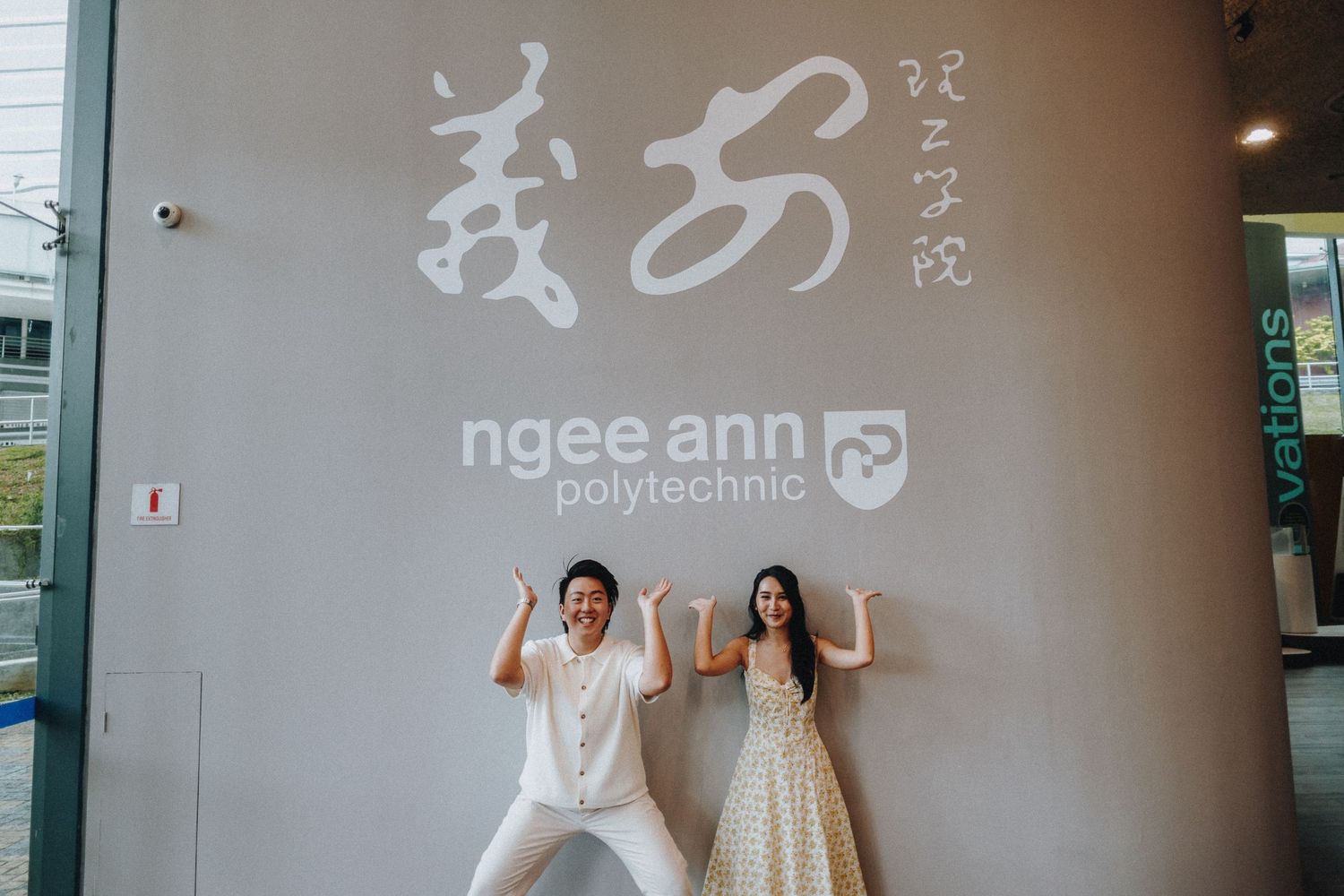 Studio wall displays 'ngee ann' branding with minimalist design elements.