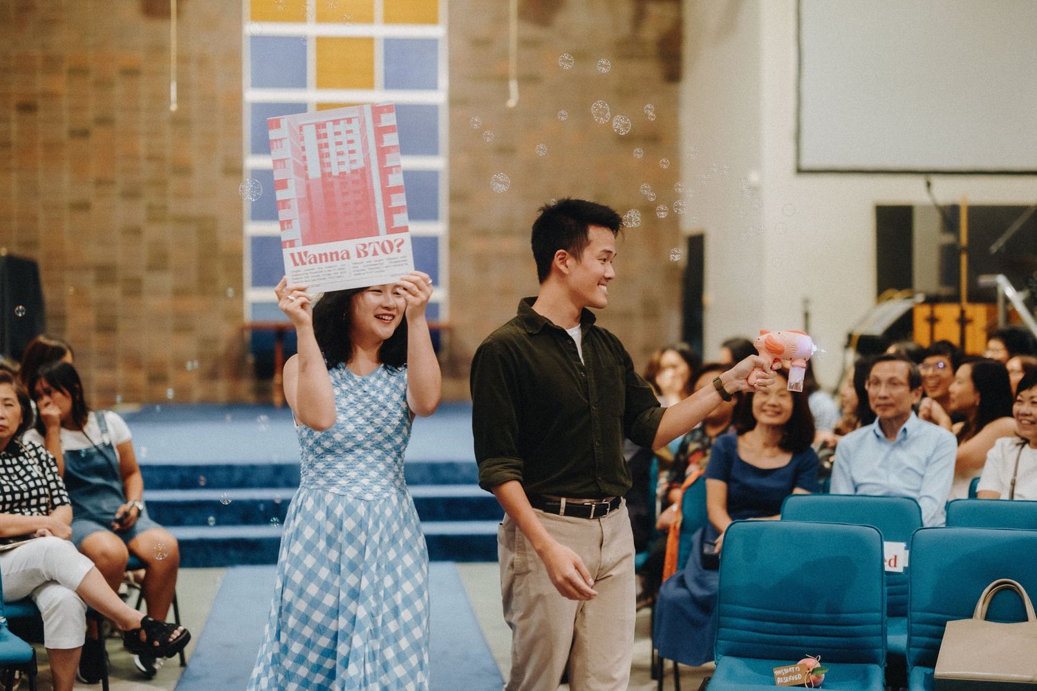 People engaging in an energetic worship service in a church with exposed brick walls.
