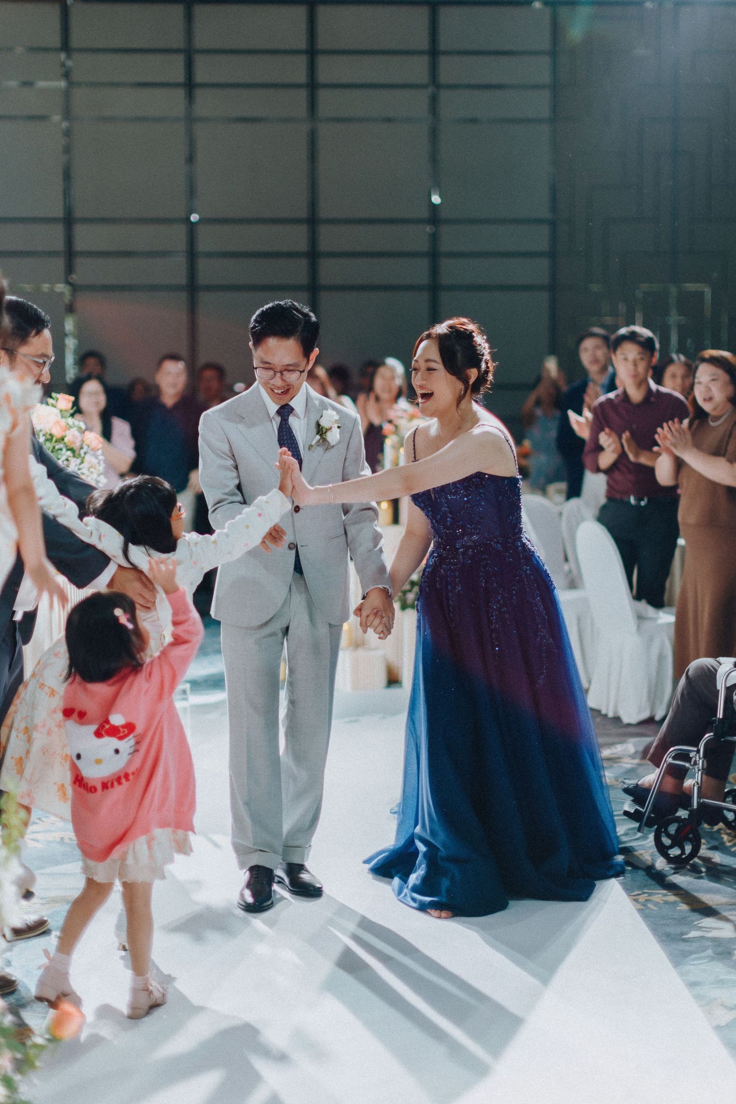Wedding reception dance floor filled with guests in formal attire enjoying lively celebration.