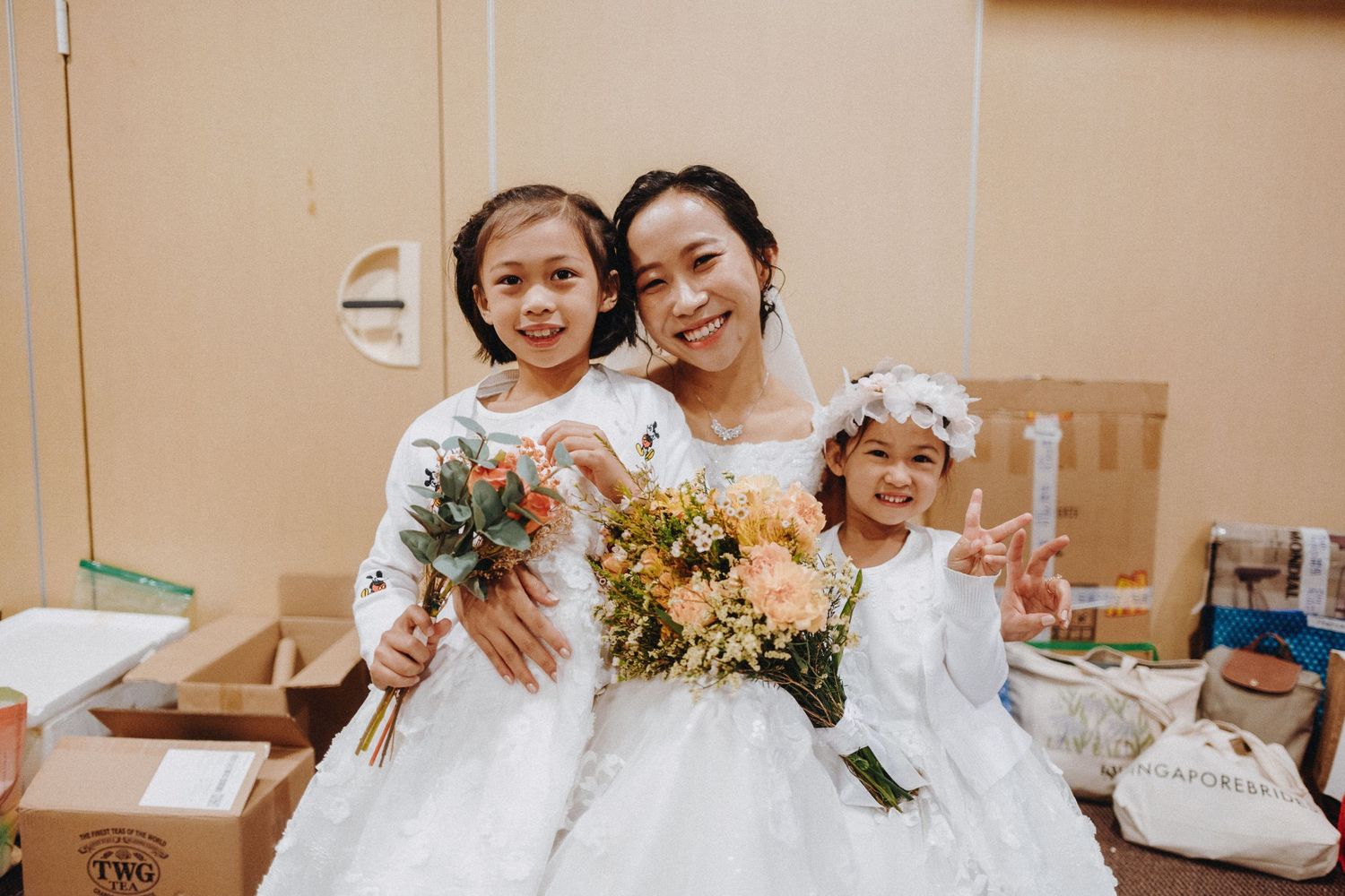 Wedding celebration lineup with floral decorations and bridesmaids in church setting.
