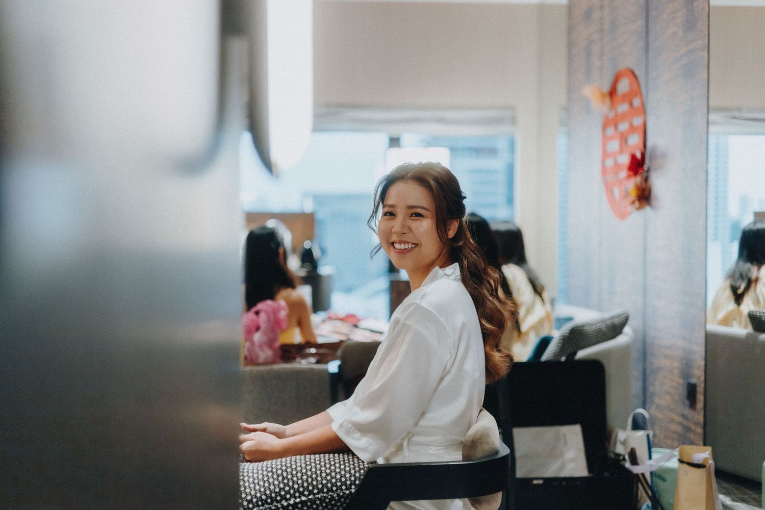 Business professionals work together at desks in a modern office space with natural lighting.
