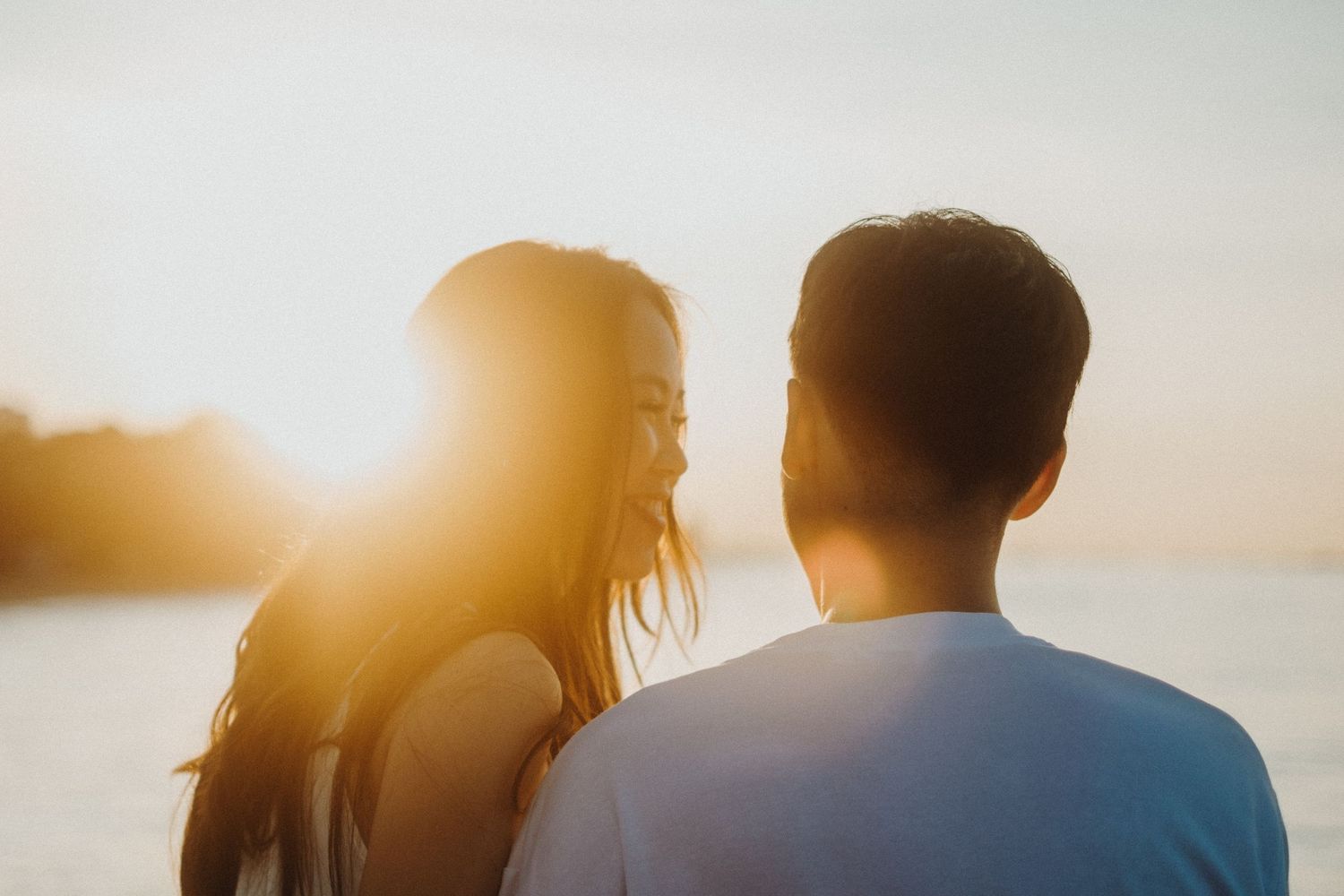 Silhouettes of people enjoying sunset views together with golden sunlight illuminating their profiles.