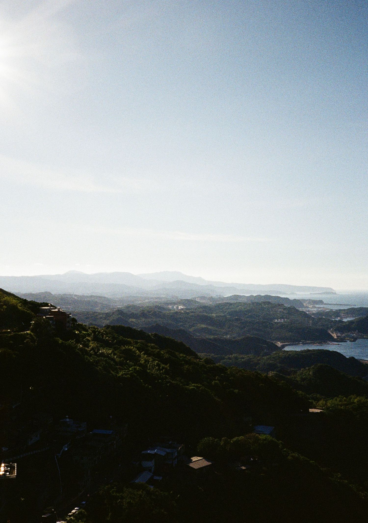 Sweeping mountain vista showcasing dramatic coastal landscapes under blue skies.