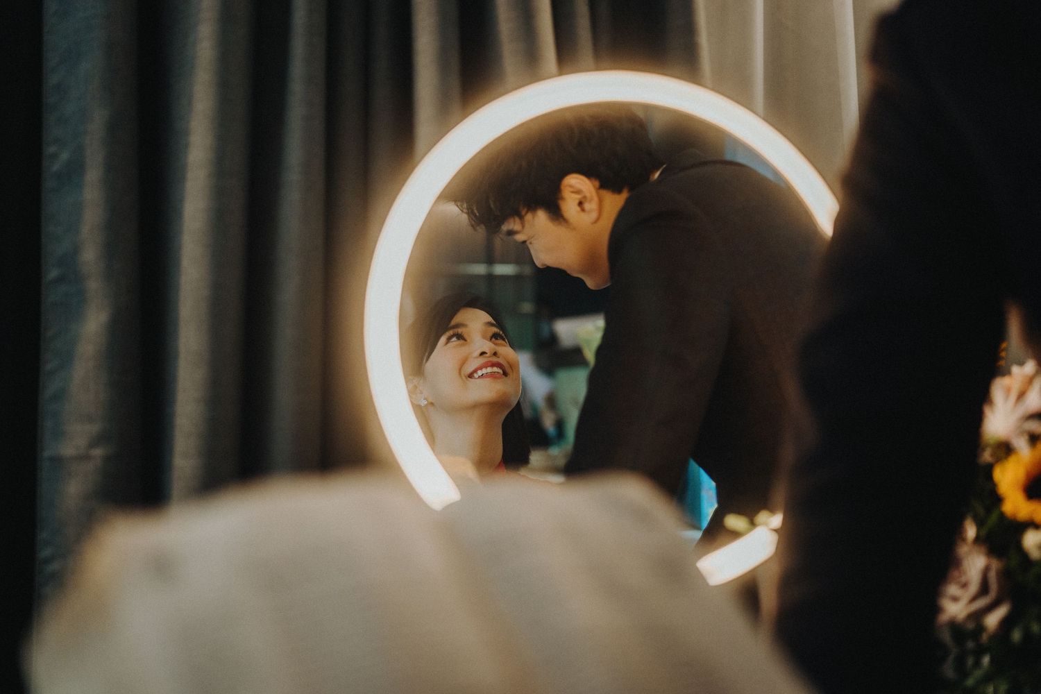 Romantic moment captured through circular ring light reflection.