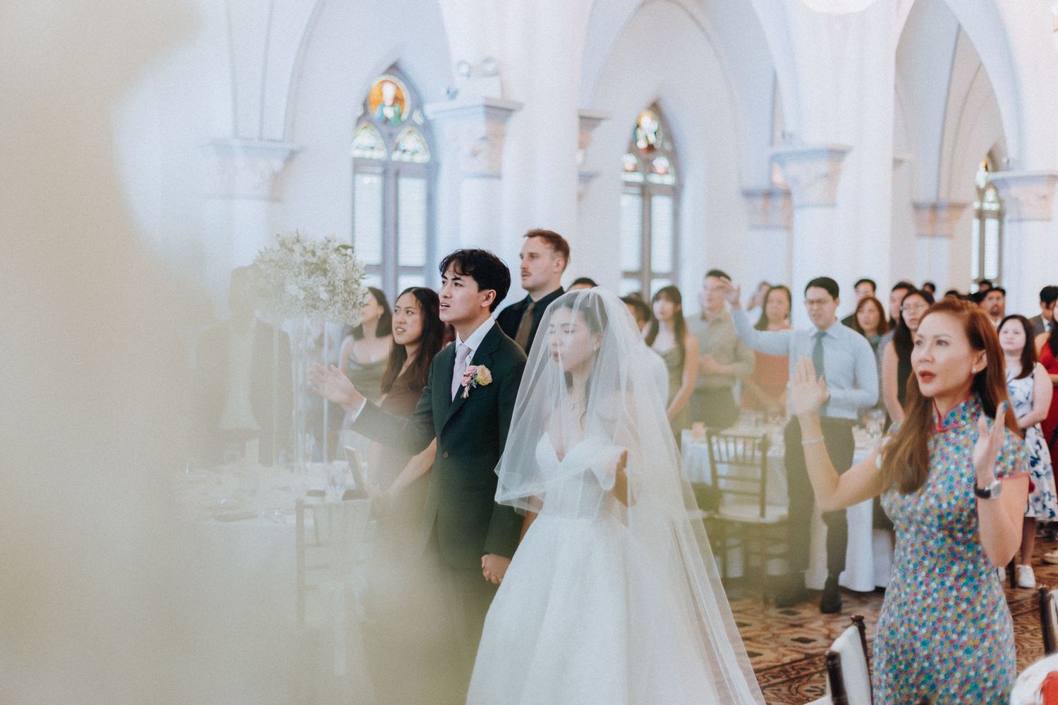 Bride and groom walk down the aisle in an elegant church wedding ceremony with guests watching.