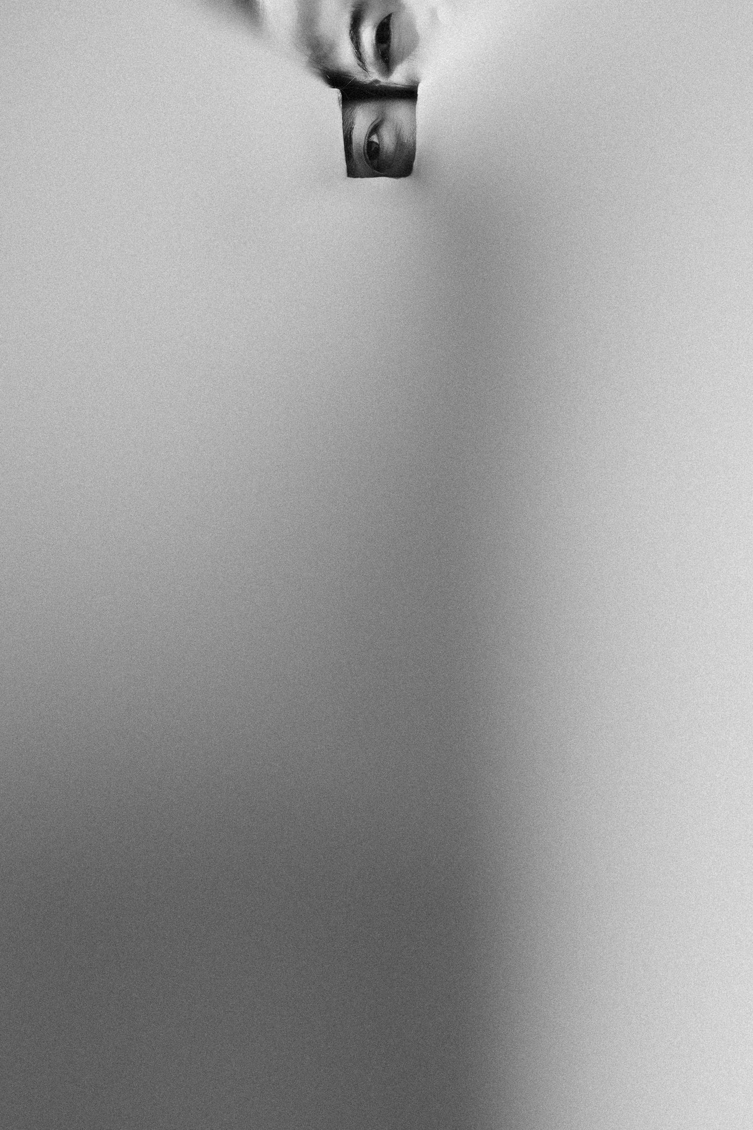 An abstract black and white gradient background with subtle lighting effects creates a moody atmosphere.