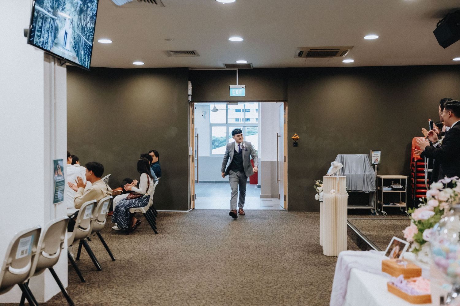 A modern wedding venue interior with chairs and floral decorations.