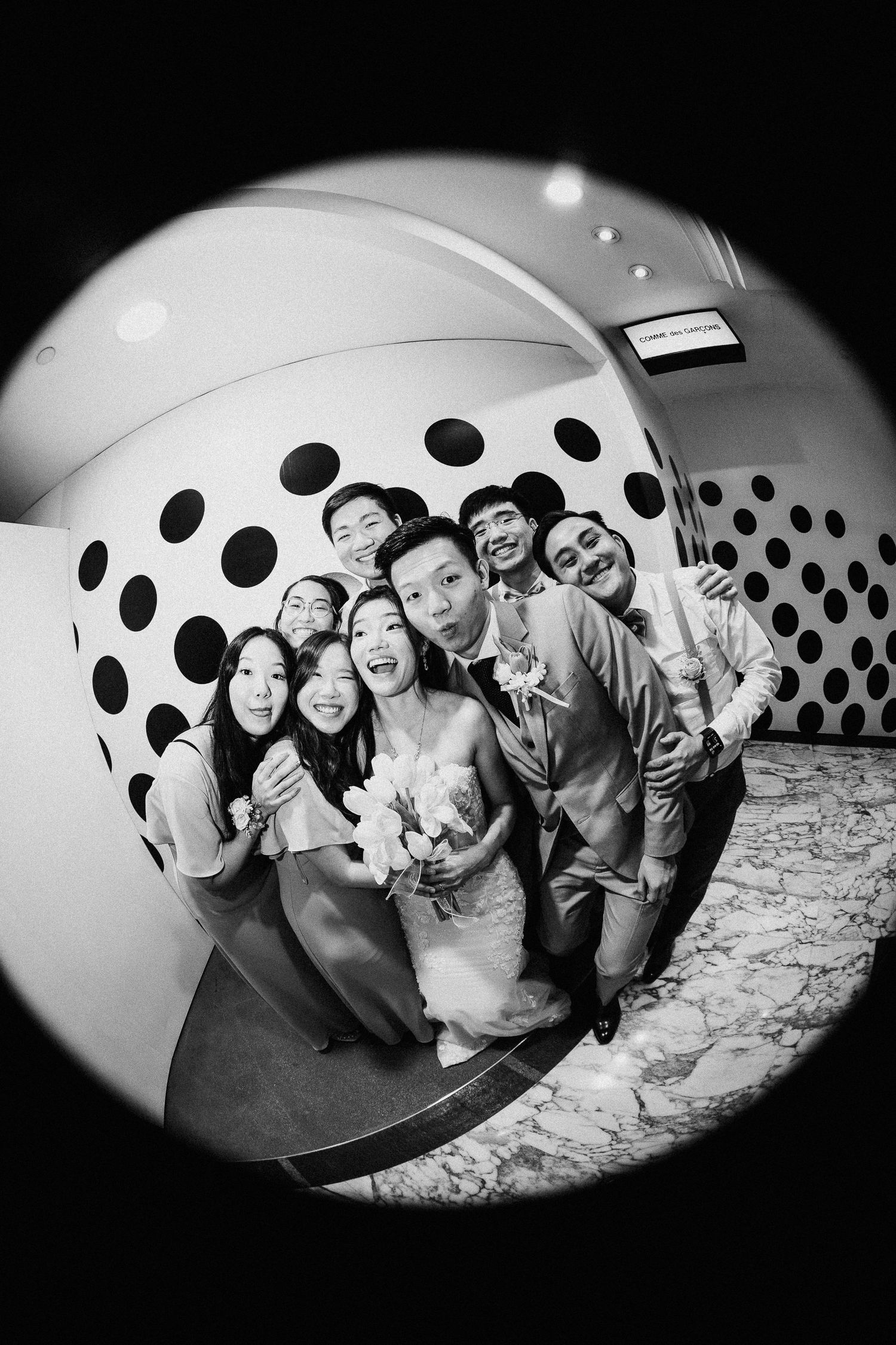Black and white fisheye lens photos showing a room with polka dot wall pattern.