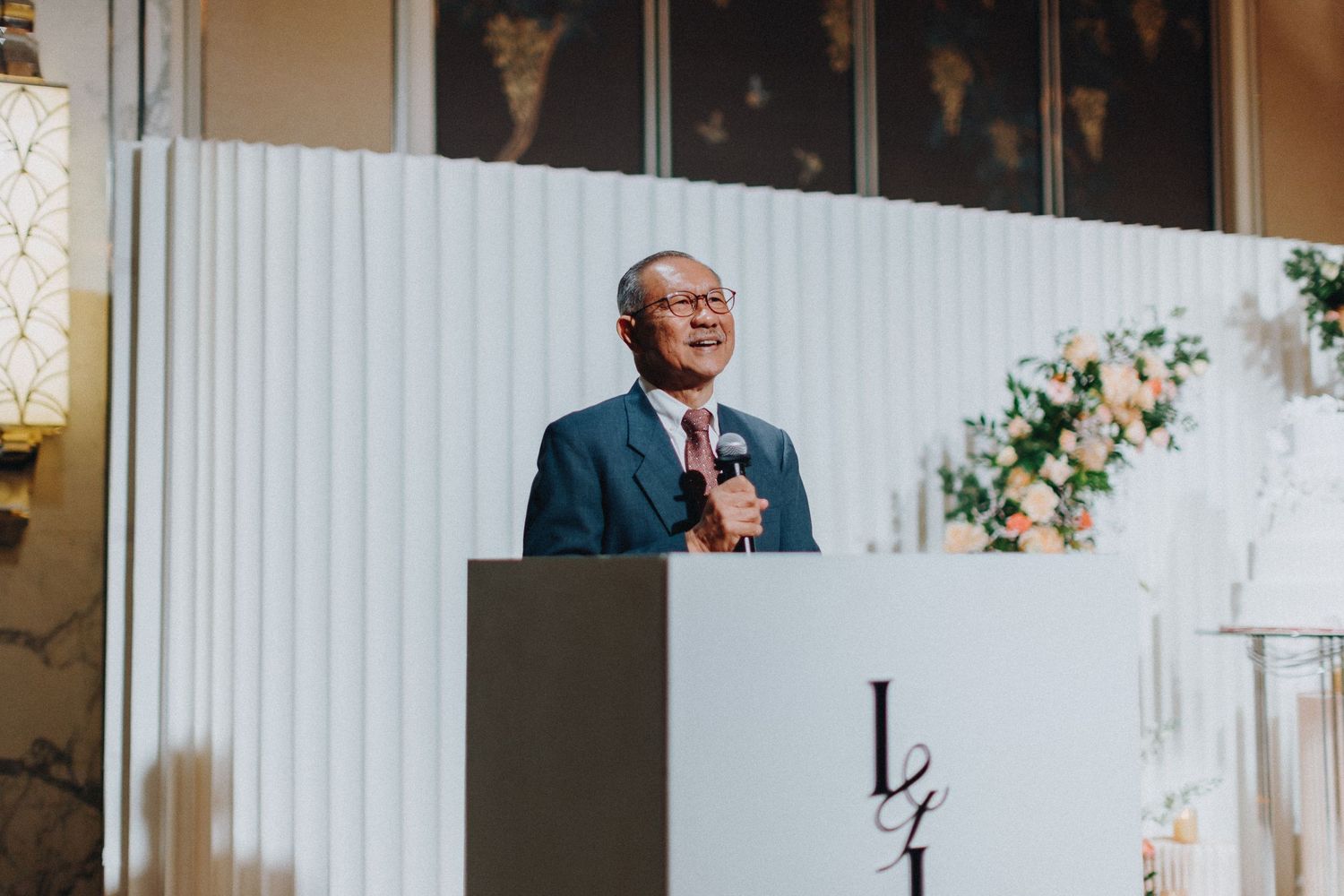 Wedding venue decorated with white panels and floral arrangements for the ceremony.