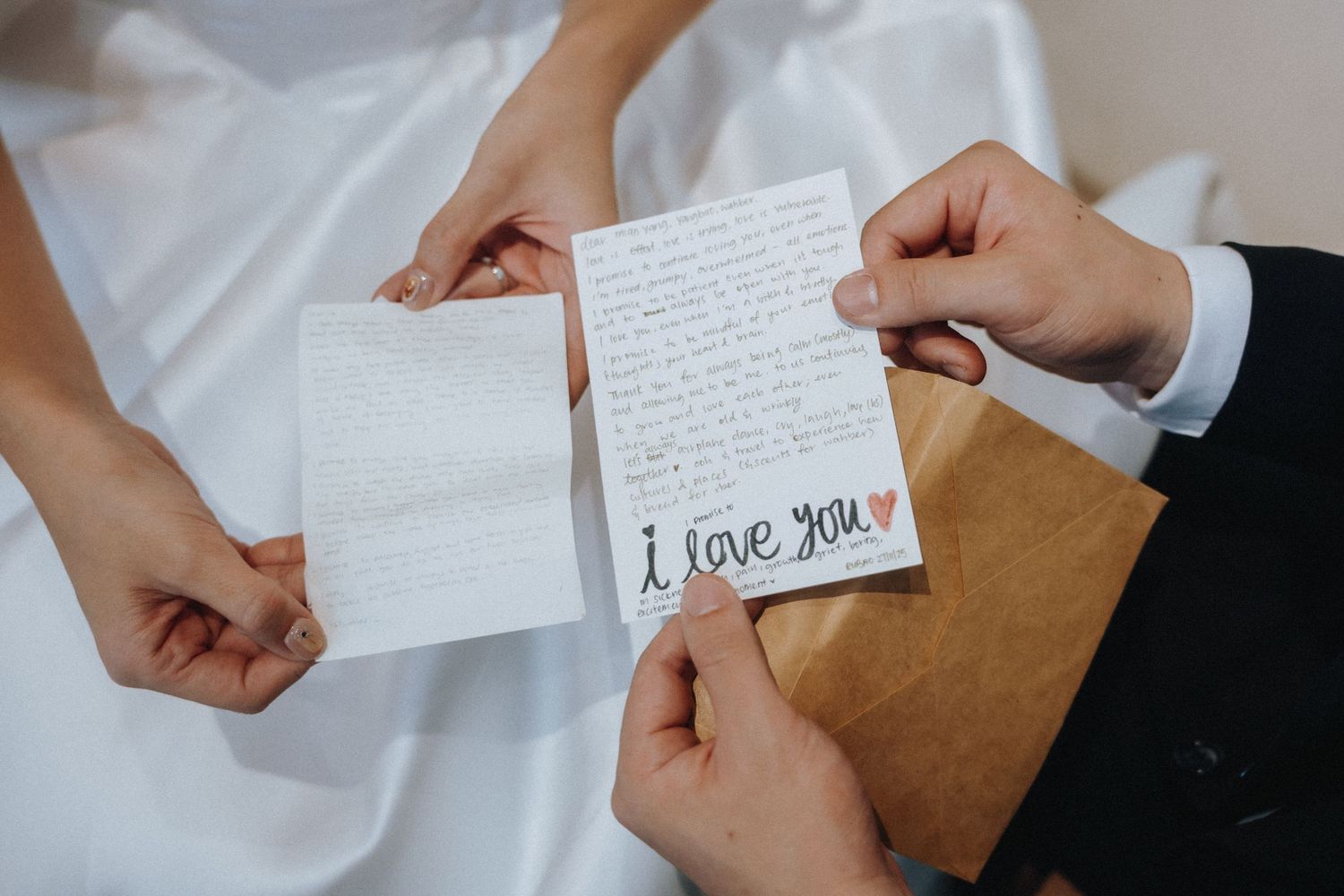 Bride and groom exchange handwritten love letters during their wedding day preparations.