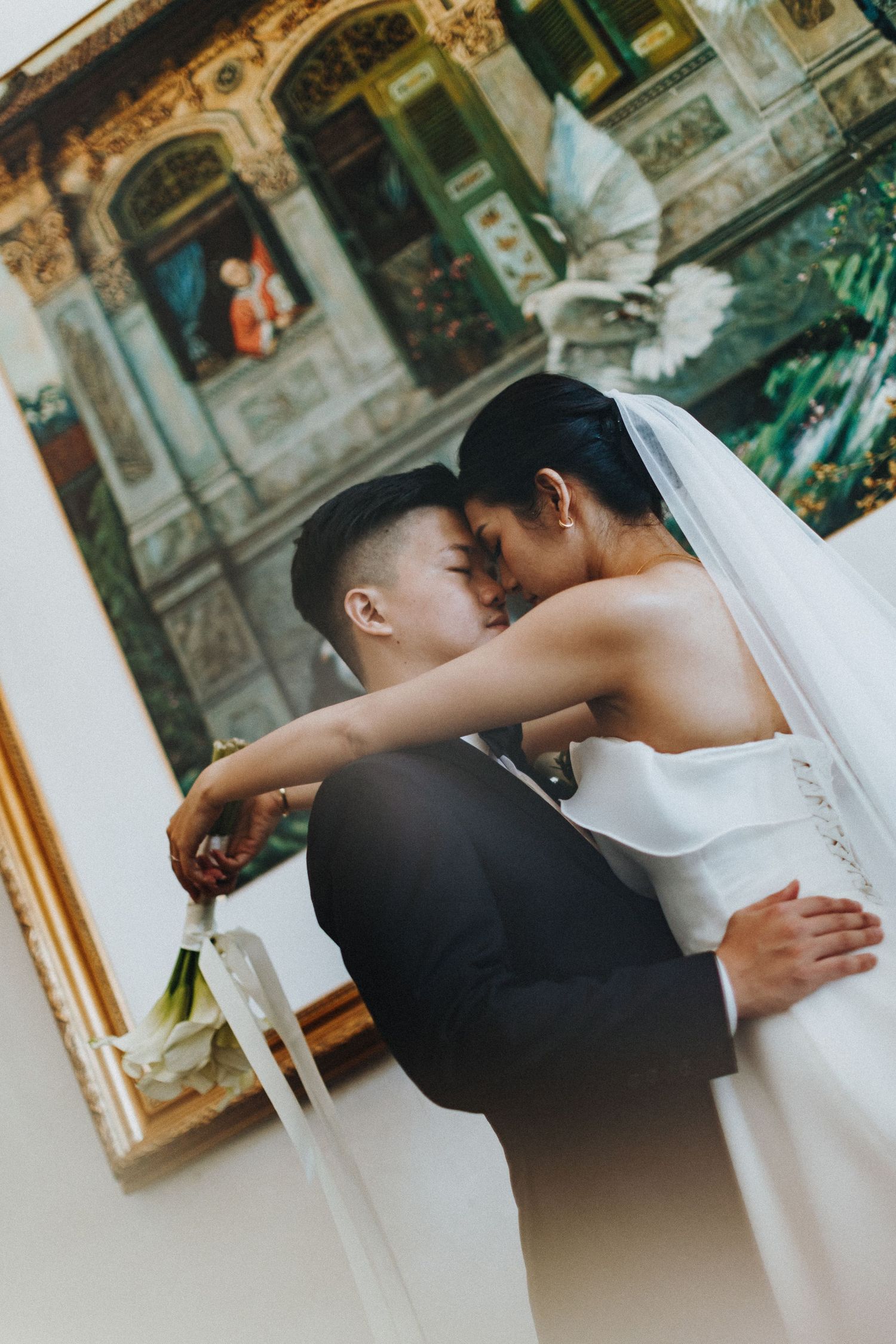 A romantic wedding moment captured in front of an ornate architectural backdrop.