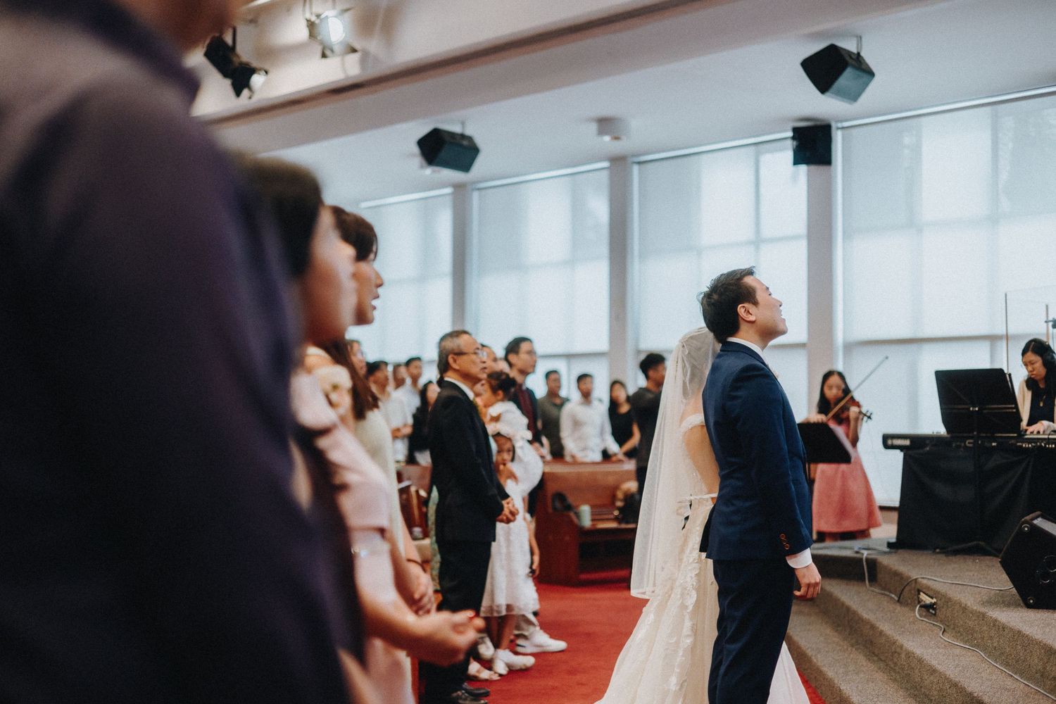 Multiple wedding ceremony photos showing bride and groom celebrating with guests at an indoor reception.