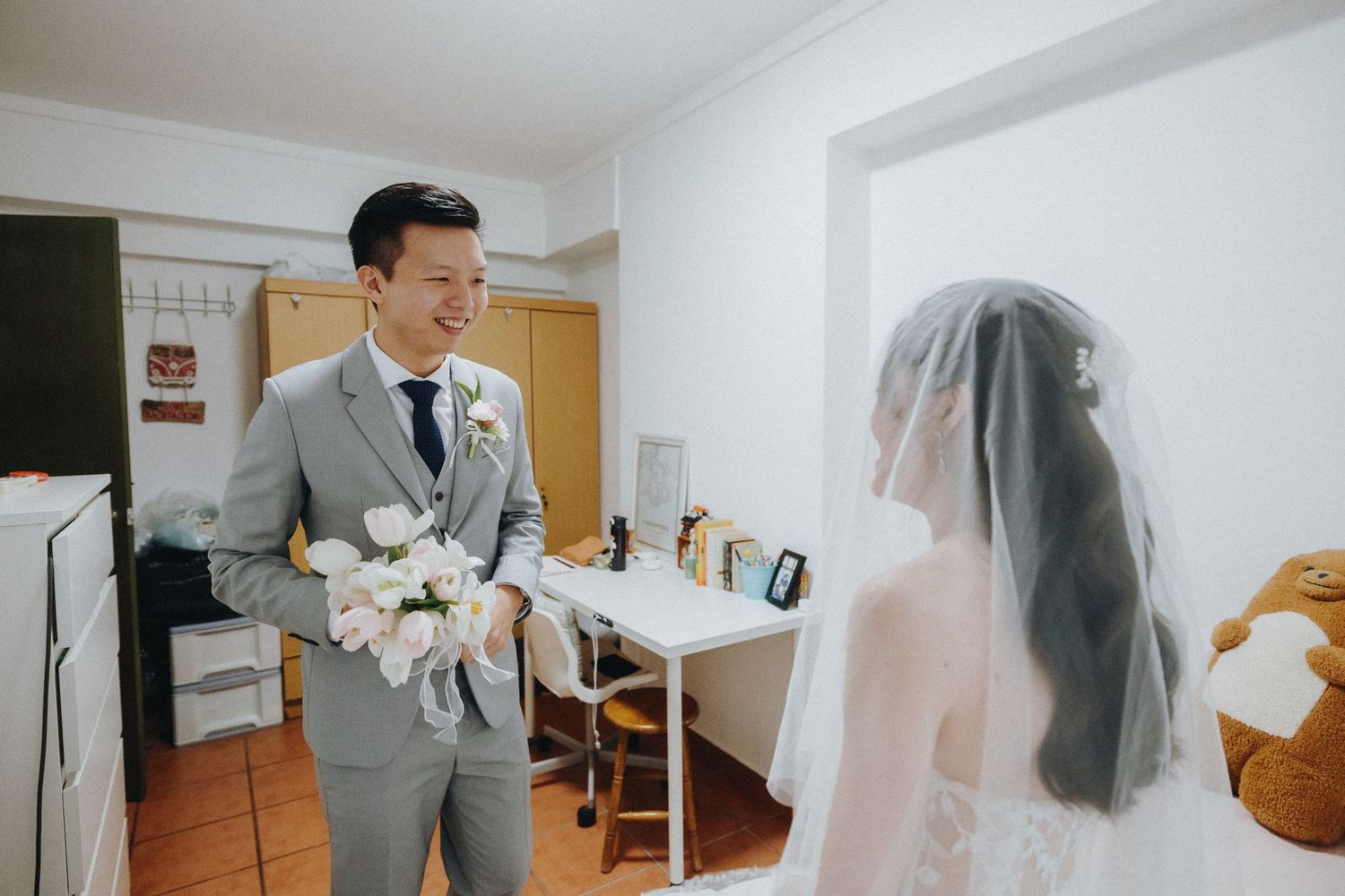 Wedding preparations in a bright modern room with clean white decor.