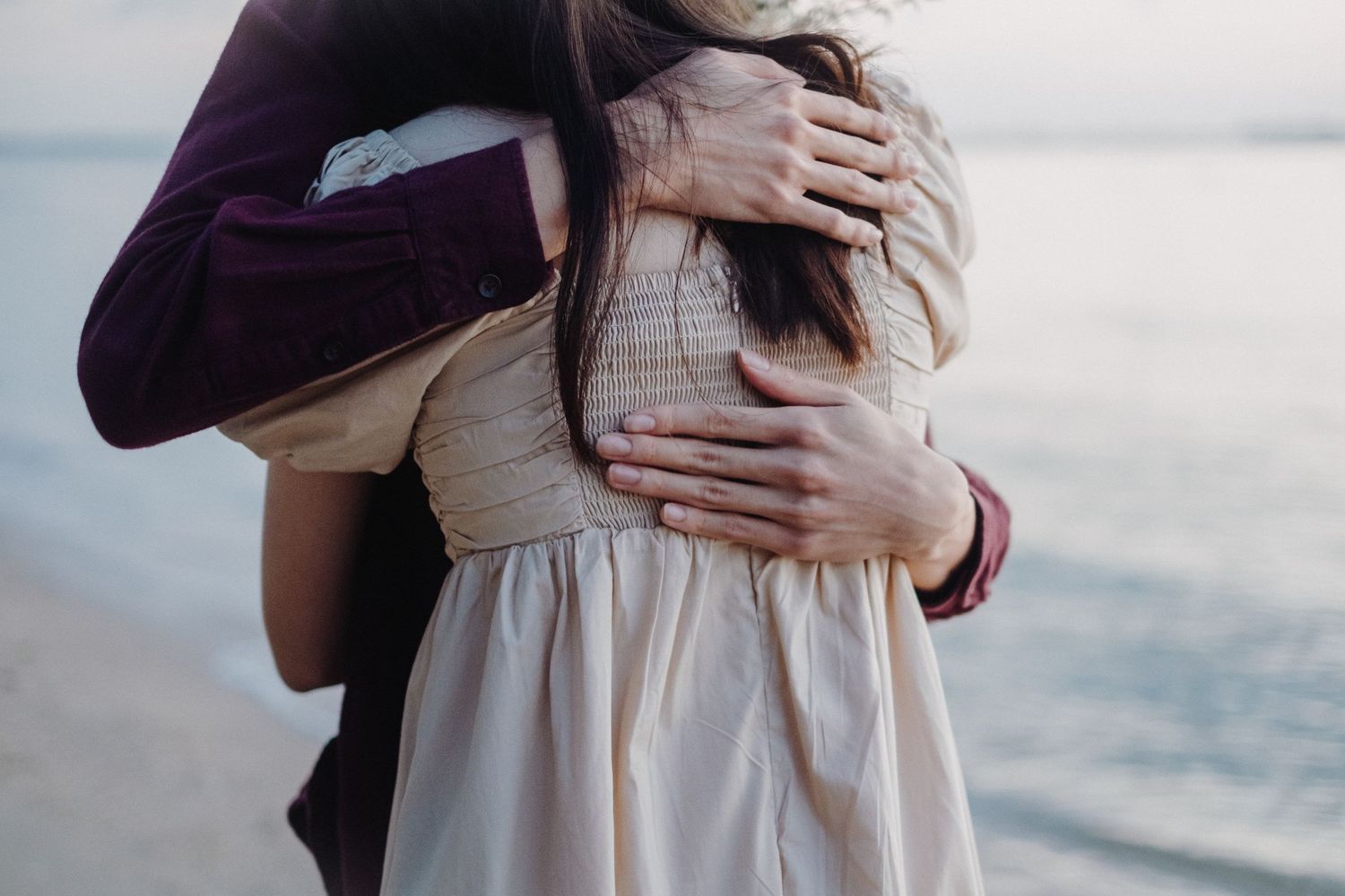 A romantic engagement photoshoot sequence showing a close embrace against a bright outdoor background.
